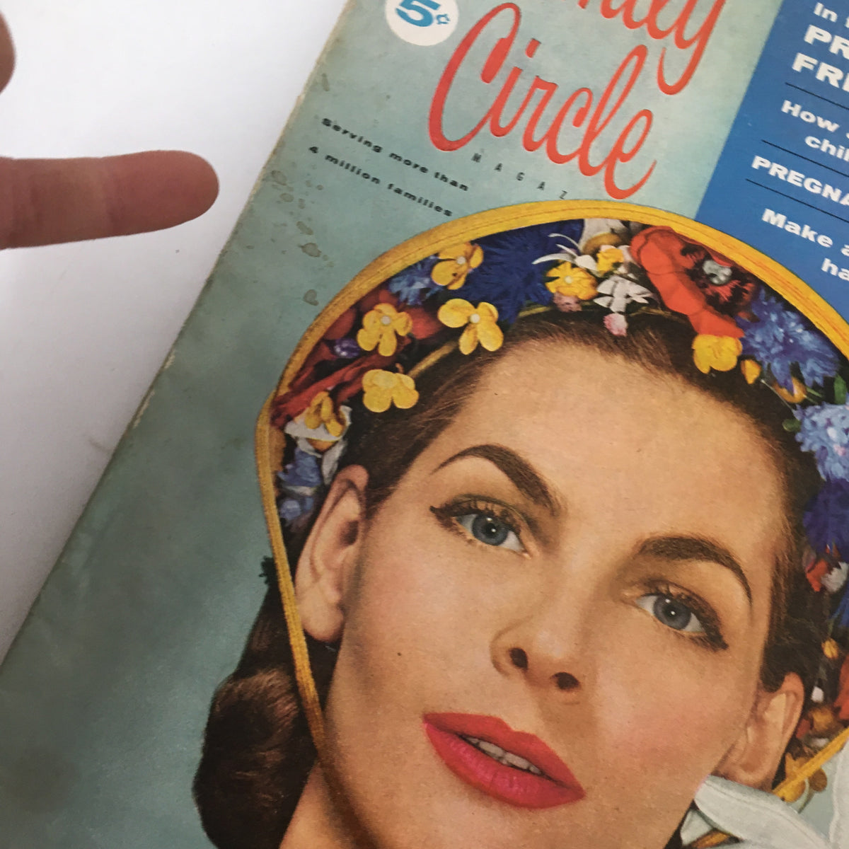 Close-up of the cover of VTG Family Circle Magazine March 1956, highlighting the woman with a floral hat and the magazine's features.