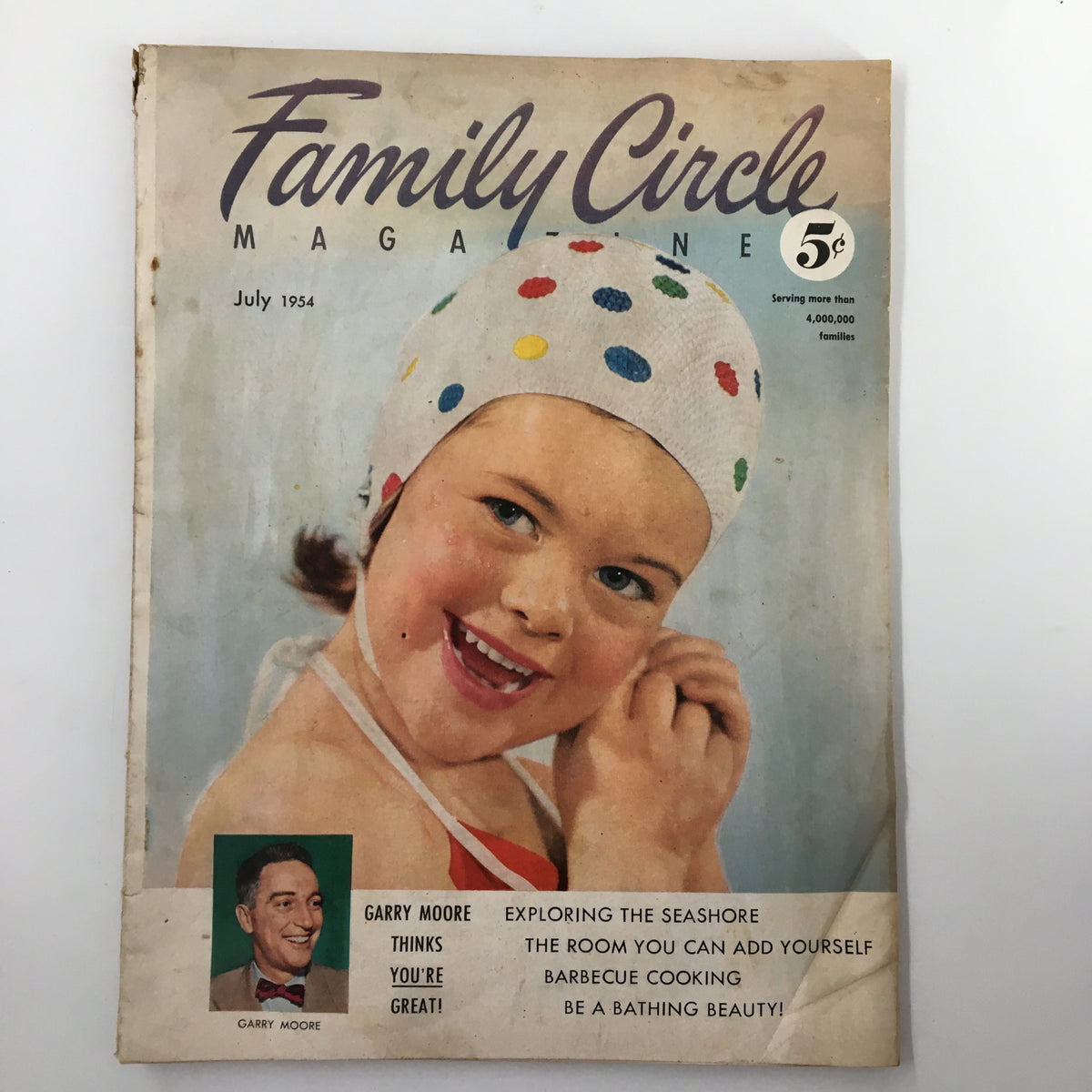 VTG Family Circle Magazine July 1954 cover featuring a smiling girl in a polka-dotted swimming cap, highlighting Garry Moore's column with text that says 'Garry Moore Thinks You're Great!'.