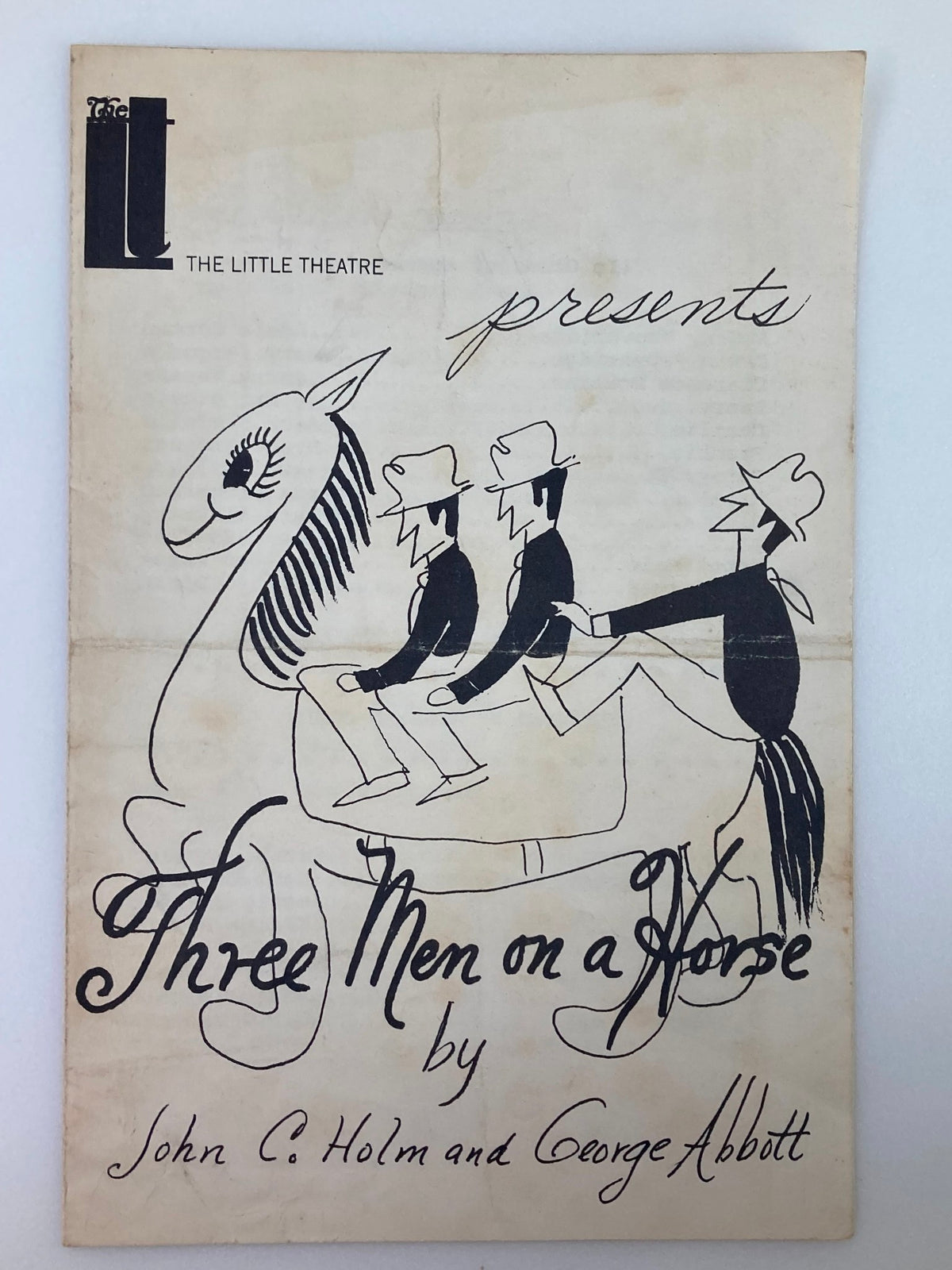 1936 The Little Theatre Program featuring Adele Carman in Three Men On A Horse, showcasing a whimsical cover illustration of characters riding a horse.
