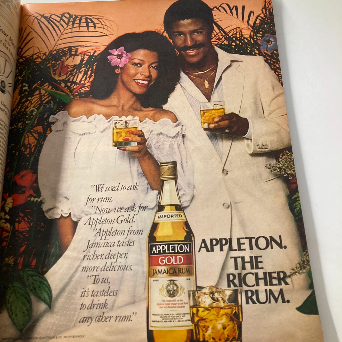 Interior advertisement from VTG Ebony Magazine June 1981 featuring a couple enjoying Appleton Gold rum, highlighting the product with a vibrant tropical background.
