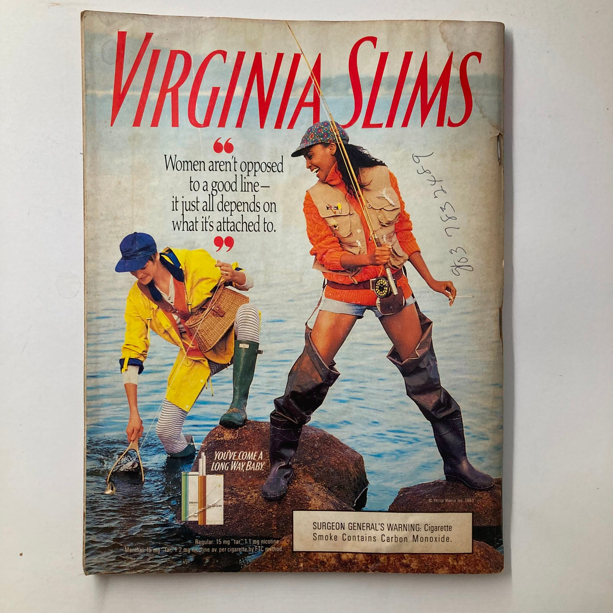 Virginia Slims advertisement featuring two women by the water, emphasizing empowerment with the quote 'Women aren't opposed to a good line - it just all depends on what it's attached to.', demonstrating vintage marketing aesthetics.