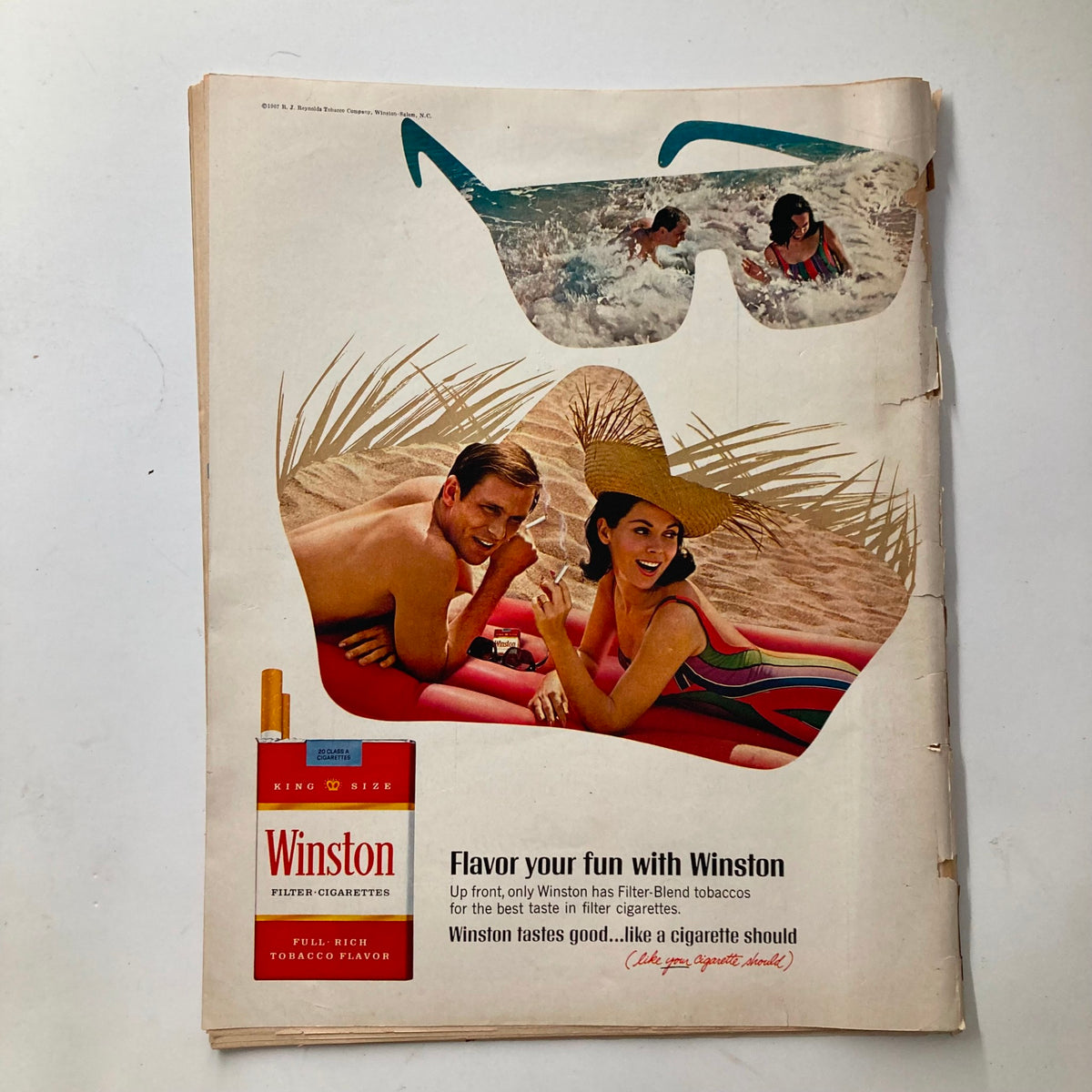Vintage Look Magazine August 20, 1968 advertisement featuring a couple at the beach with sunglasses, promoting Winston cigarettes, showcasing mid-20th century design and culture.