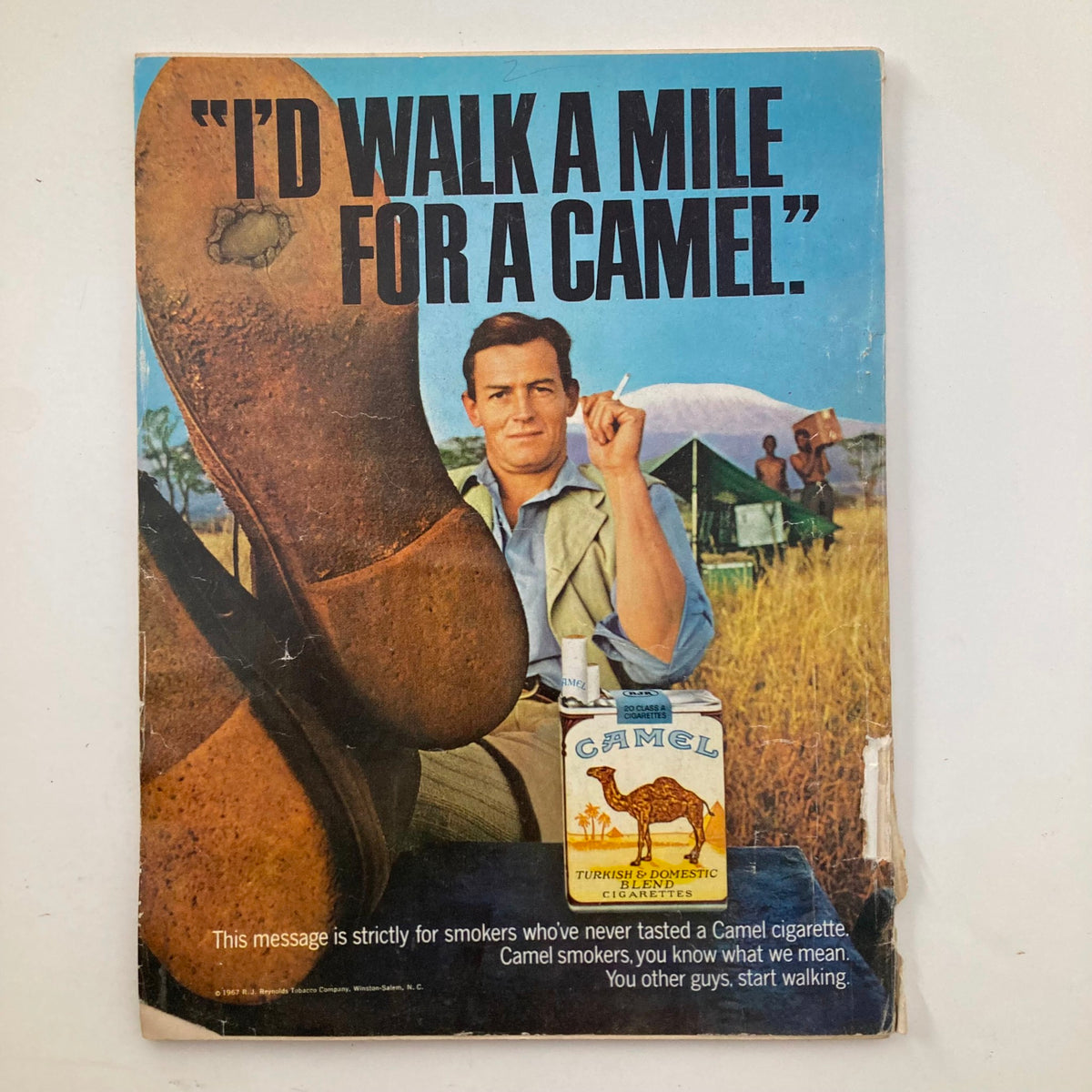Back cover of TRUE The Man's Magazine January 1968 featuring a Camel cigarette advertisement with a tagline, 'I’d walk a mile for a camel'.
