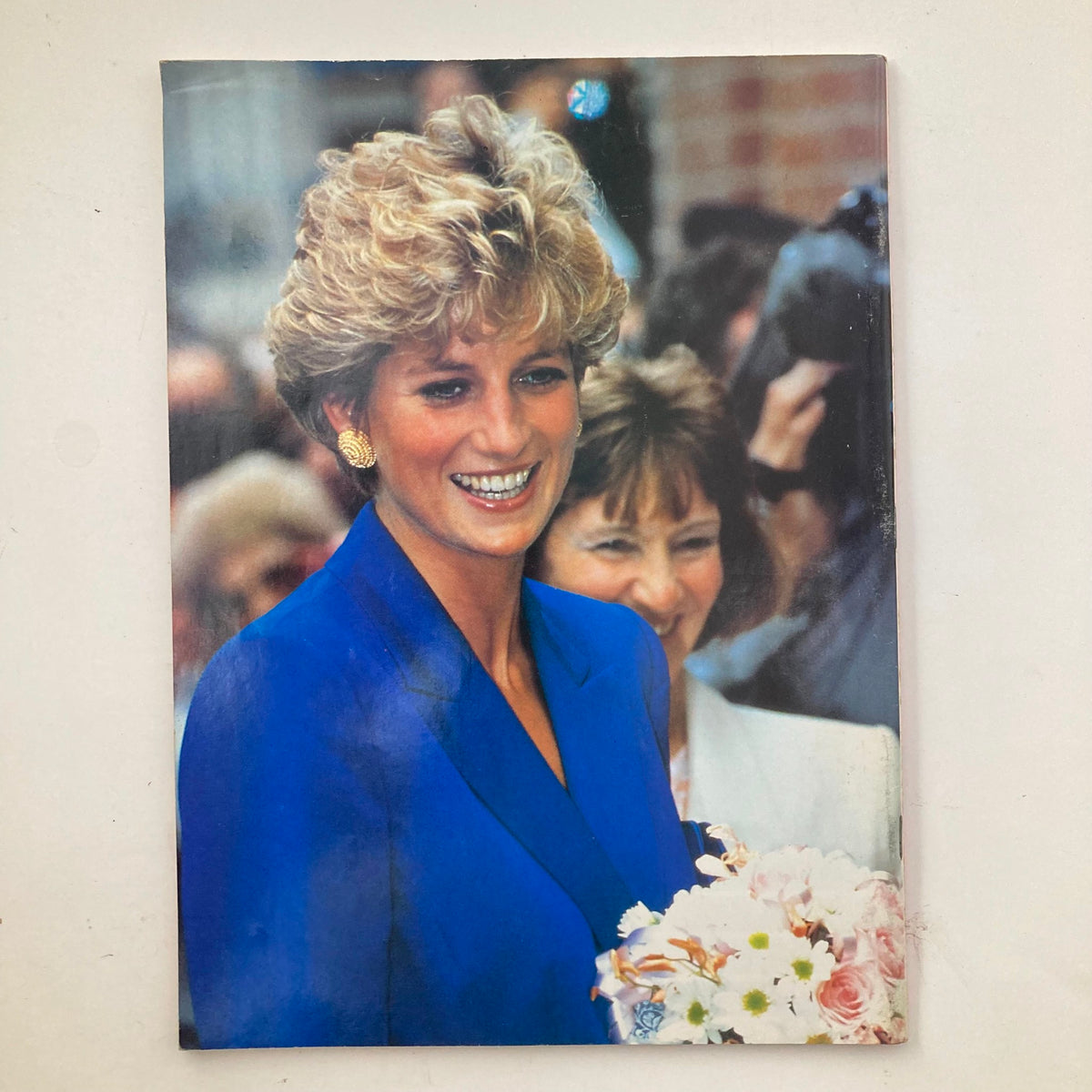 Back cover of the 1997 Biograph Magazine Tribute to Princess Diana, showcasing a vibrant image of her smiling while holding flowers.