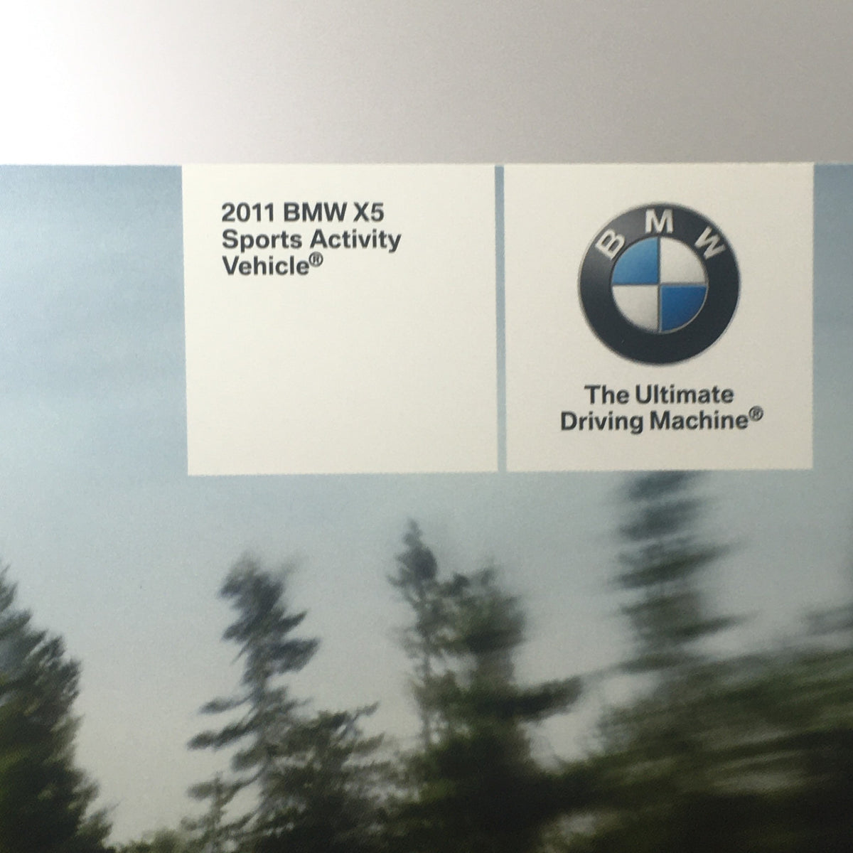 Cover of the 2011 BMW X5 Sports Activity Vehicle Dealership Car Auto Brochure Catalog featuring the BMW logo and tagline 'The Ultimate Driving Machine'.