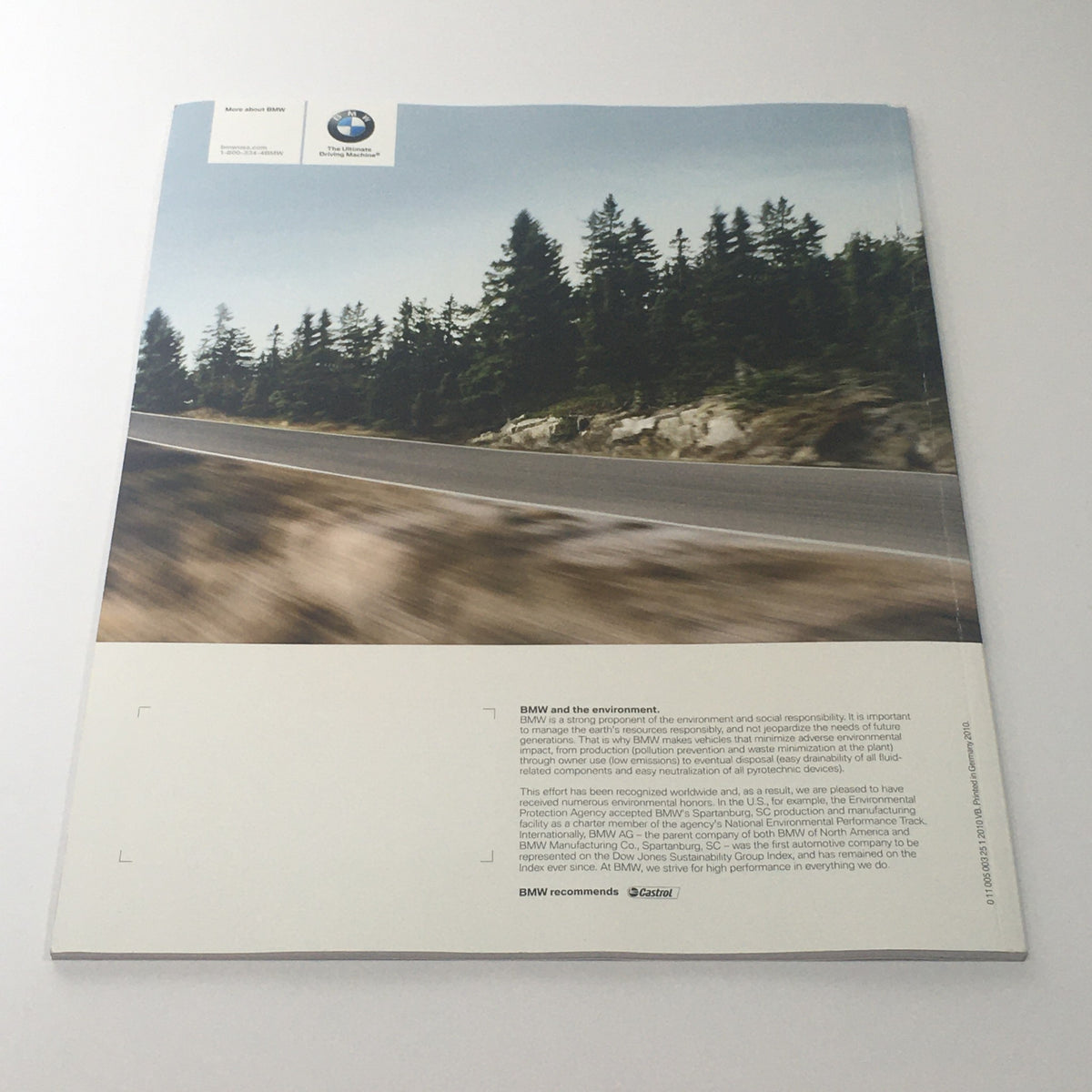 Back cover of the 2011 BMW X5 Sports Activity Vehicle Dealership Car Auto Brochure displaying a scenic road view with a message about BMW's commitment to environmental sustainability.