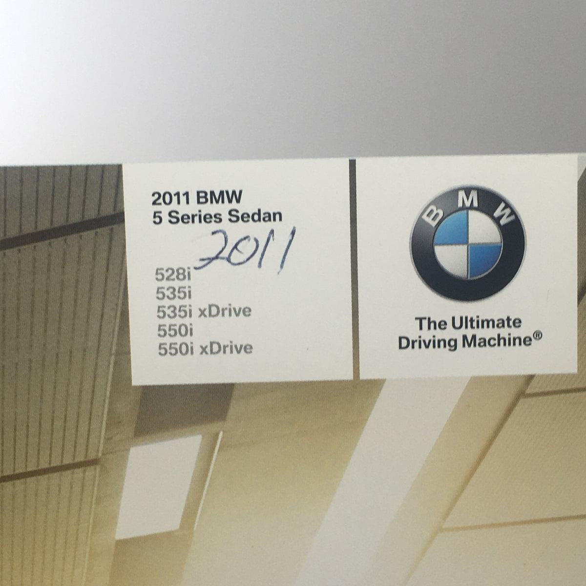 Detailed view of the 2011 BMW 5 Series Sedan brochure featuring the name and models 528i, 535i, and 550i with BMW branding.