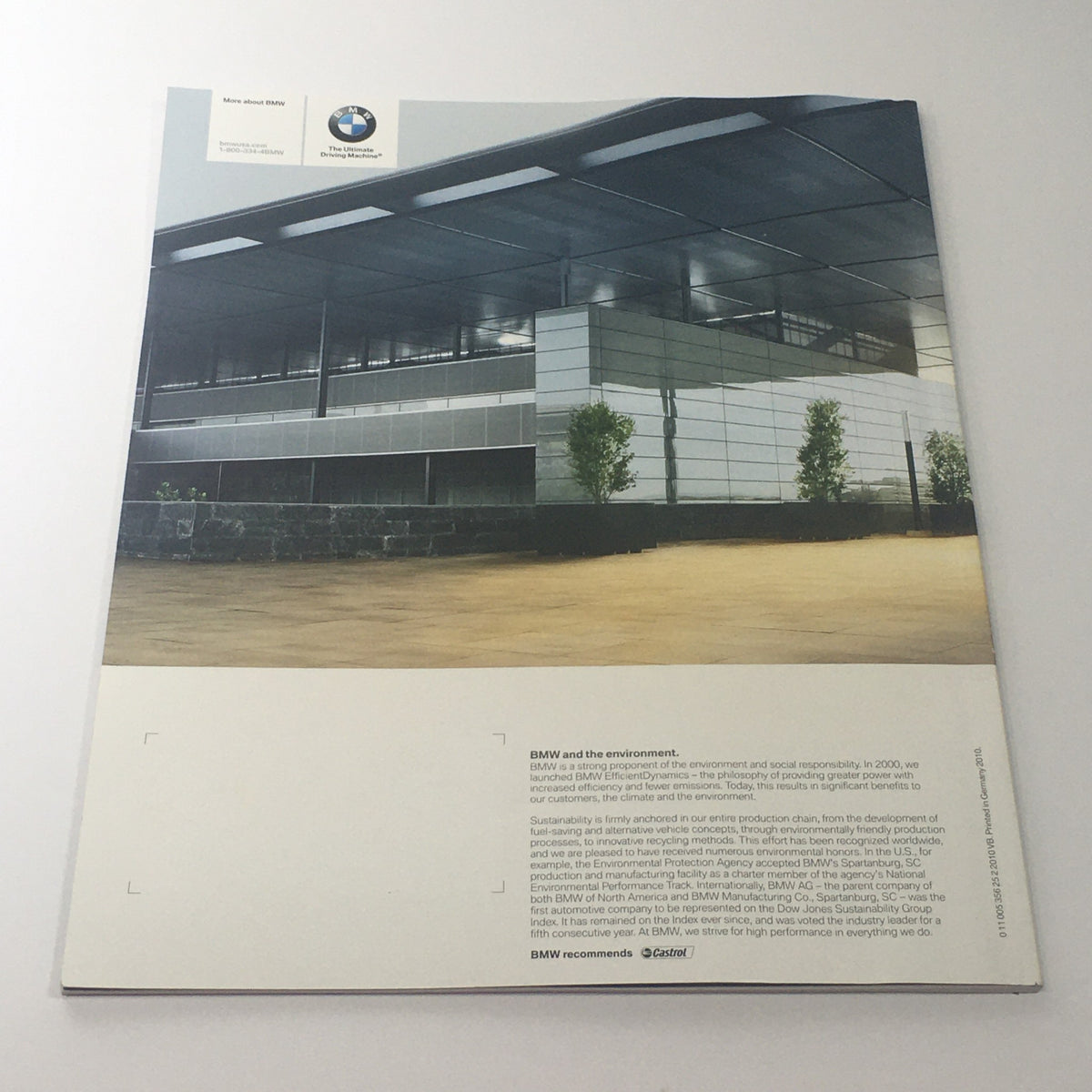2011 BMW 5 Series Sedan 528i 535i 550i X-D Dealership Car Auto Brochure Catalog featuring a modern BMW dealership exterior with lush landscaping.