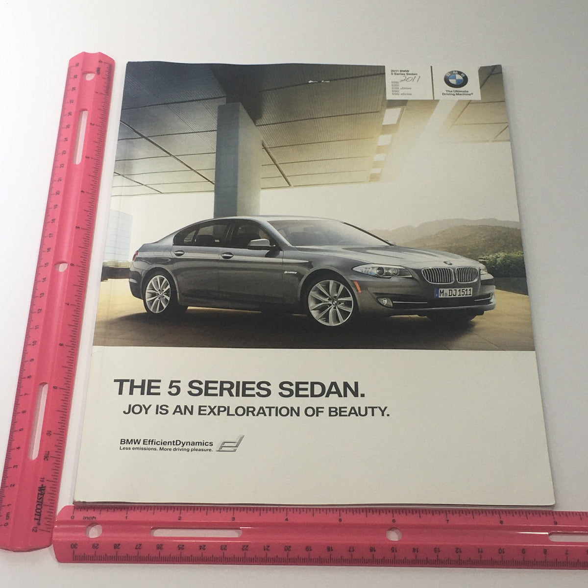2011 BMW 5 Series Sedan 528i 535i 550i X-D Dealership Car Auto Brochure Catalog cover displaying the 5 Series Sedan with the tagline 'Joy is an Exploration of Beauty'.