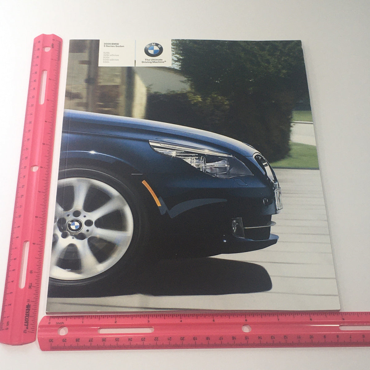 Front cover of the 2009 BMW 5 Series Sedan 528i 535i 550i Dealership Car Auto Brochure Catalog, showcasing a close-up view of the BMW vehicle's front end.