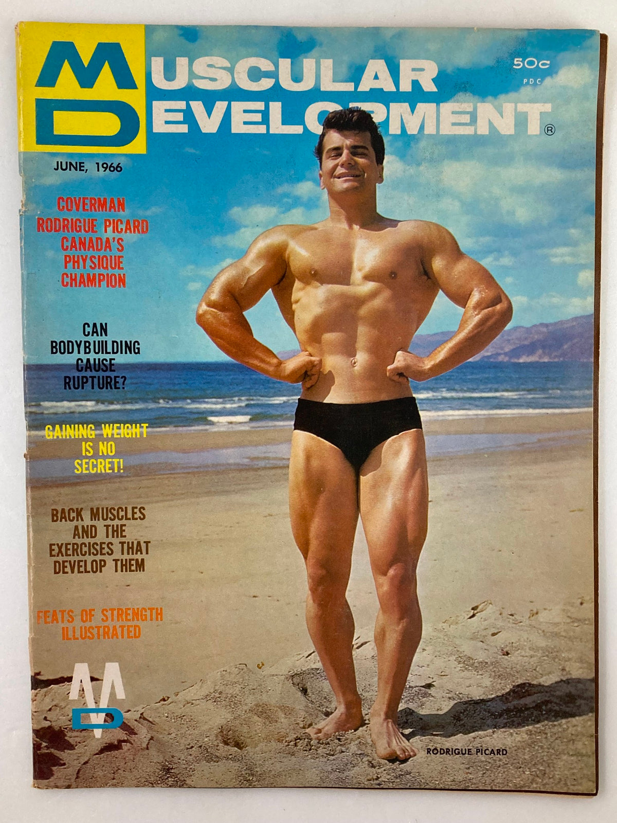VTG Muscular Development Magazine June 1966 featuring Rodrigue Picard on the cover, showcasing his muscular physique against a beach backdrop.