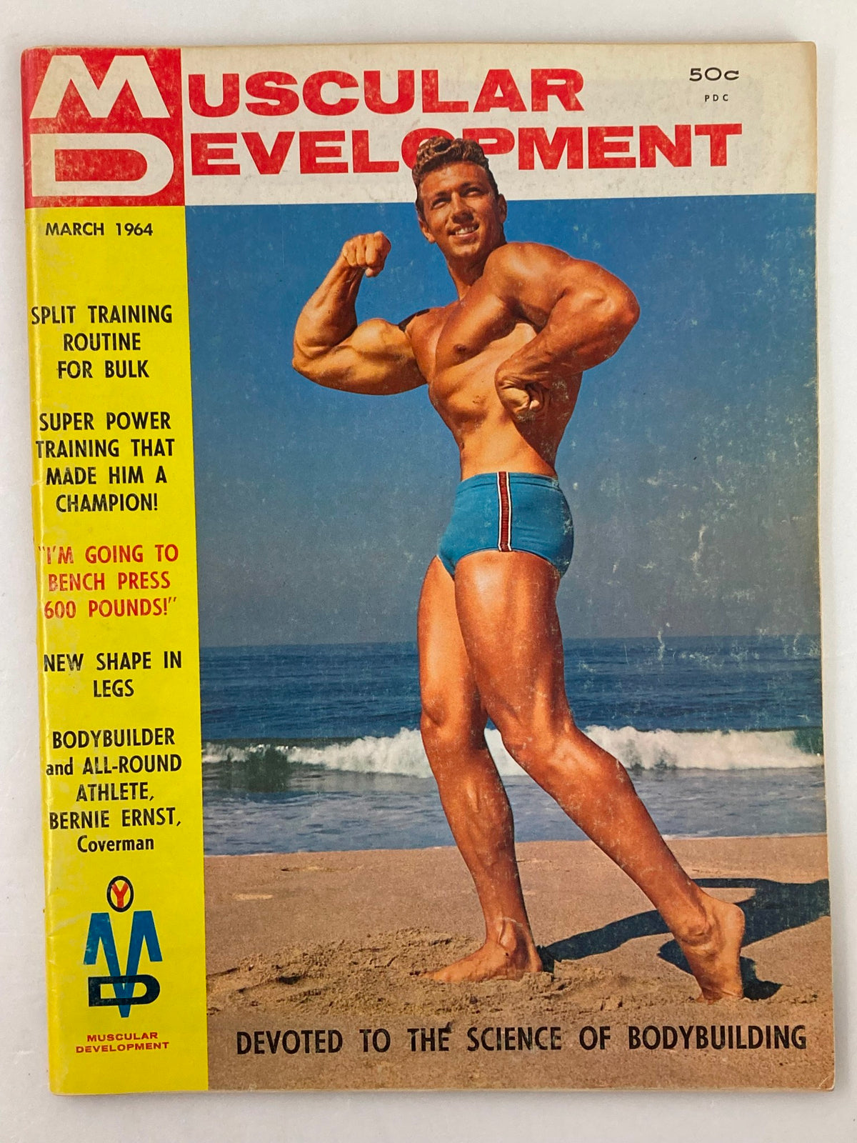 Cover of VTG Muscular Development Magazine March 1964 Vol 1 #3 featuring Bernie Ernst posing on the beach, showcasing bodybuilding culture of the 1960s.