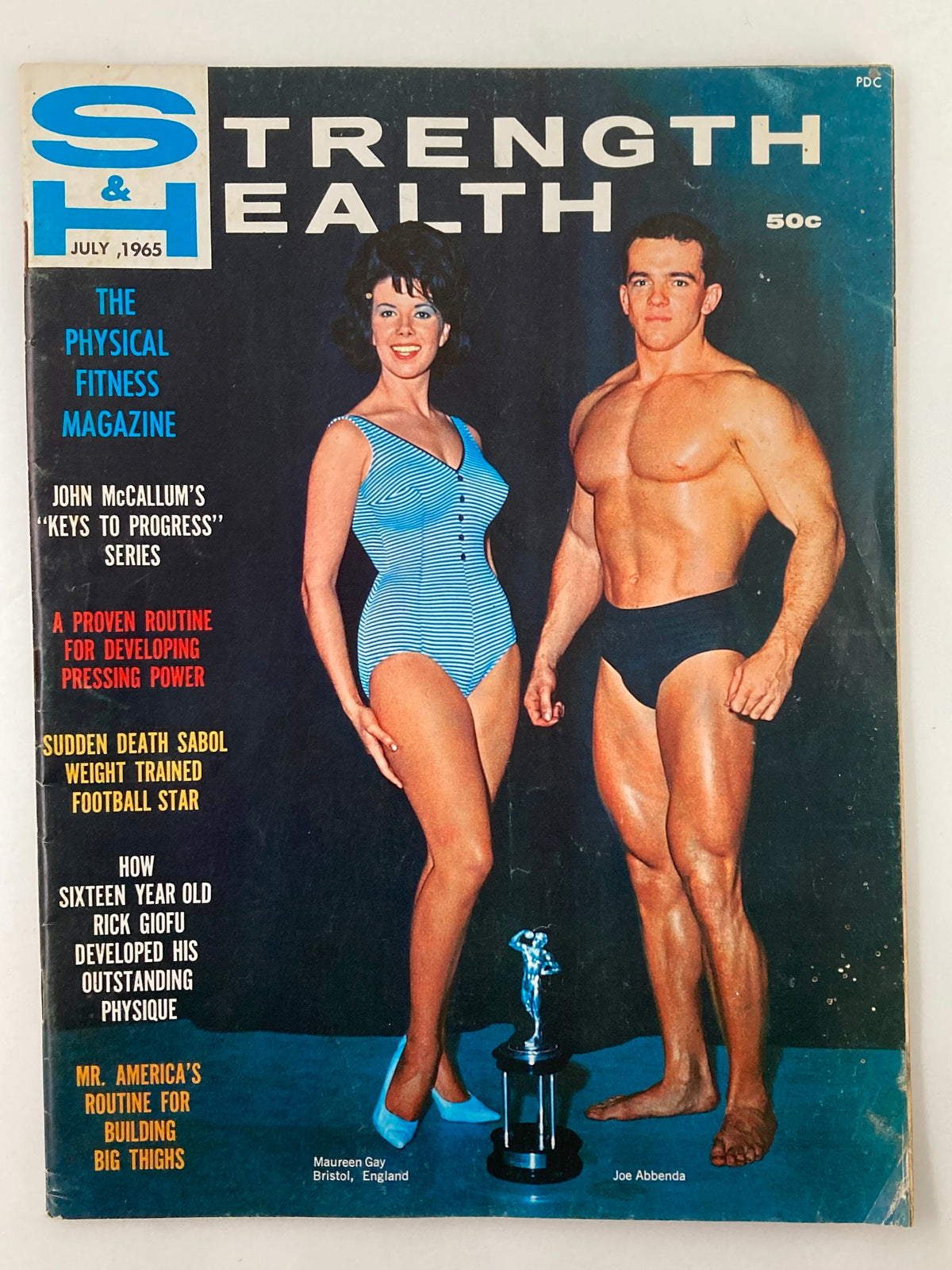 Cover of VTG Strength & Health Magazine July 1965, featuring Maureen Gay and Joe Abbenda, showcasing fitness culture of the 1960s.