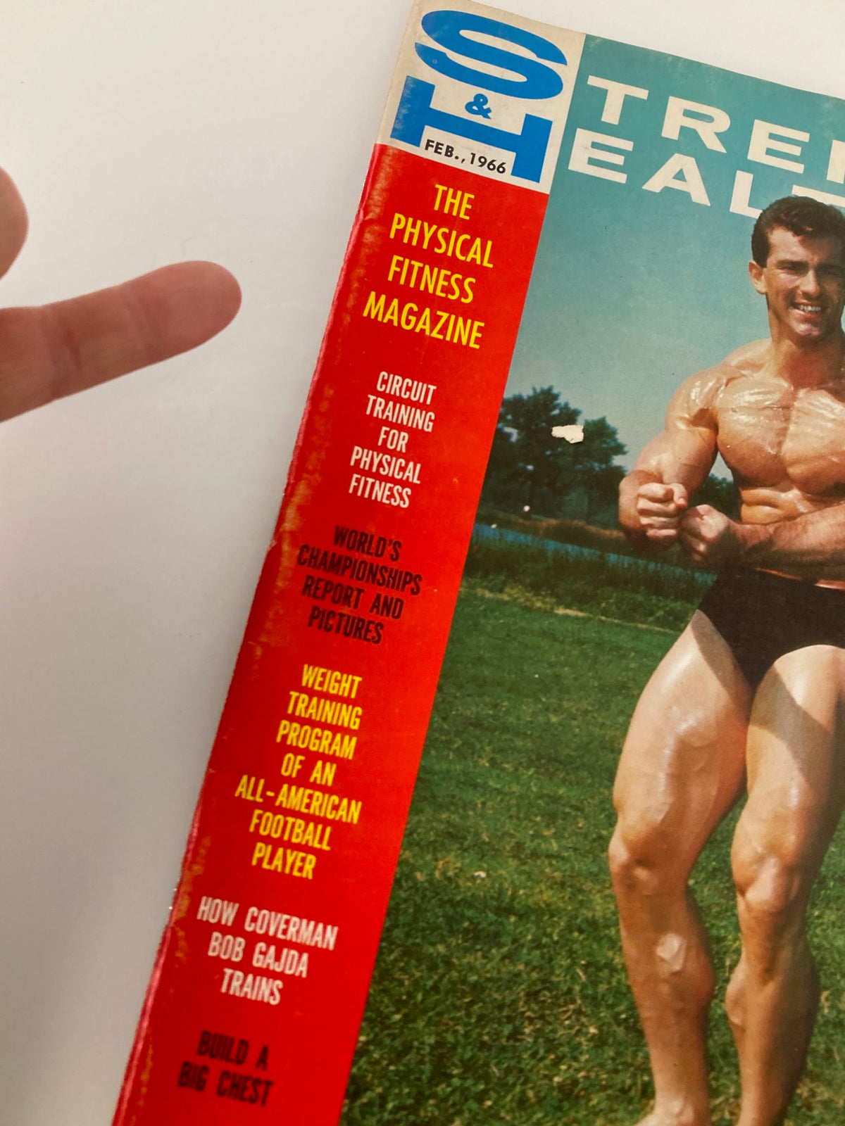 Close-up view of the cover of VTG Strength & Health Magazine February 1966 Vol 34 #2 highlighting the title and Bob Gajda's athletic image.
