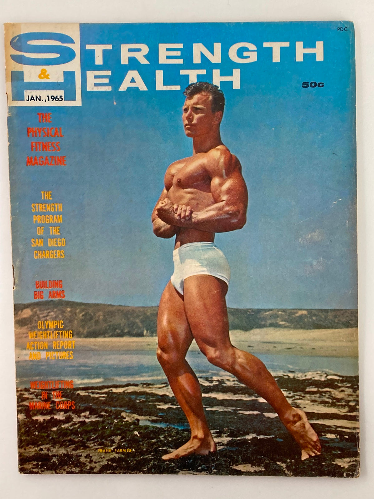 Cover of VTG Strength & Health Magazine, January 1965, featuring Frank Farmer. The magazine showcases a muscular man on a beach, highlighting fitness themes and articles relevant to the era.