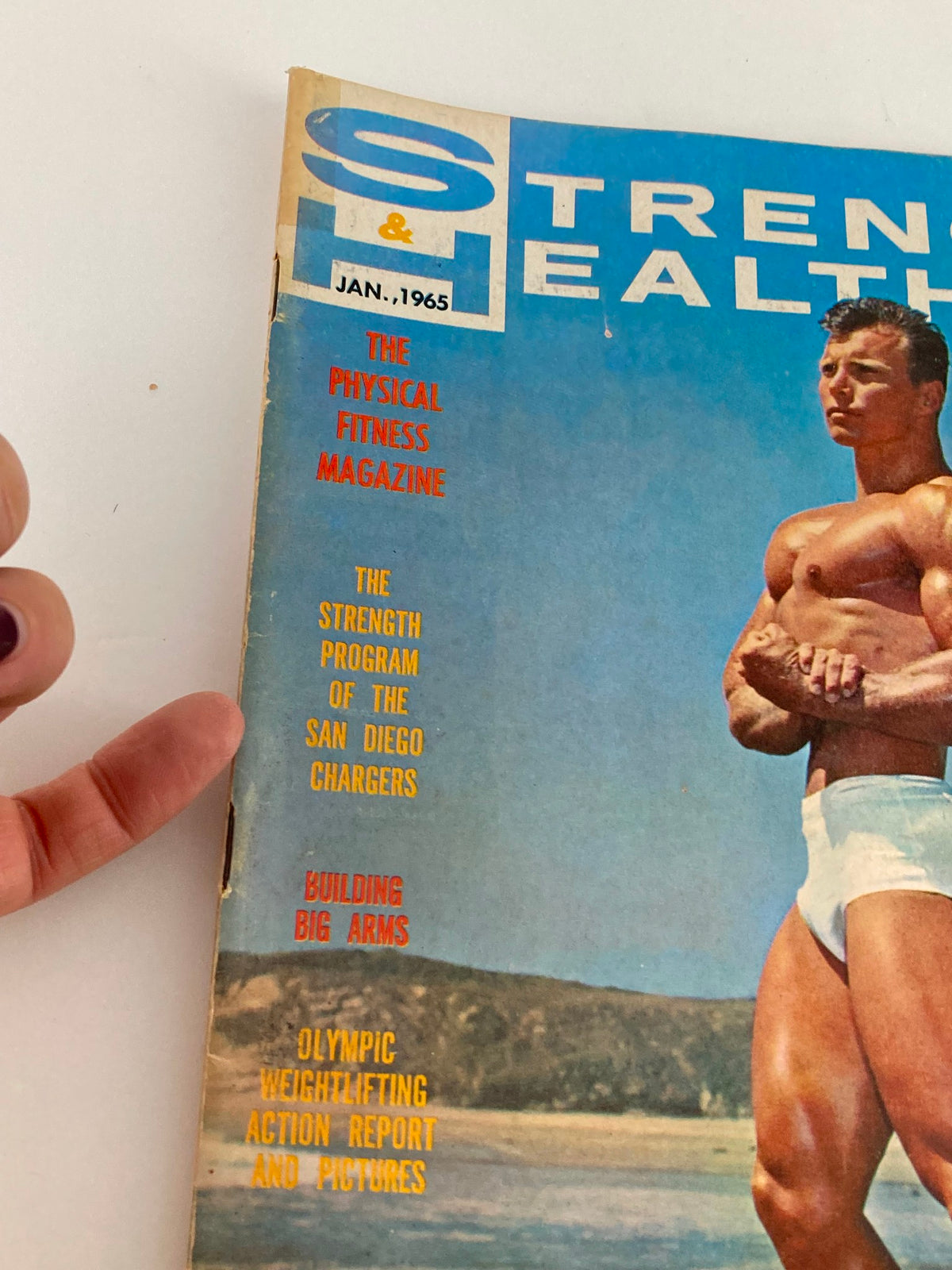 Cover of VTG Strength & Health Magazine January 1965 featuring Frank Farmer, highlights physical fitness topics, including 'Building Big Arms' and Olympic weightlifting.