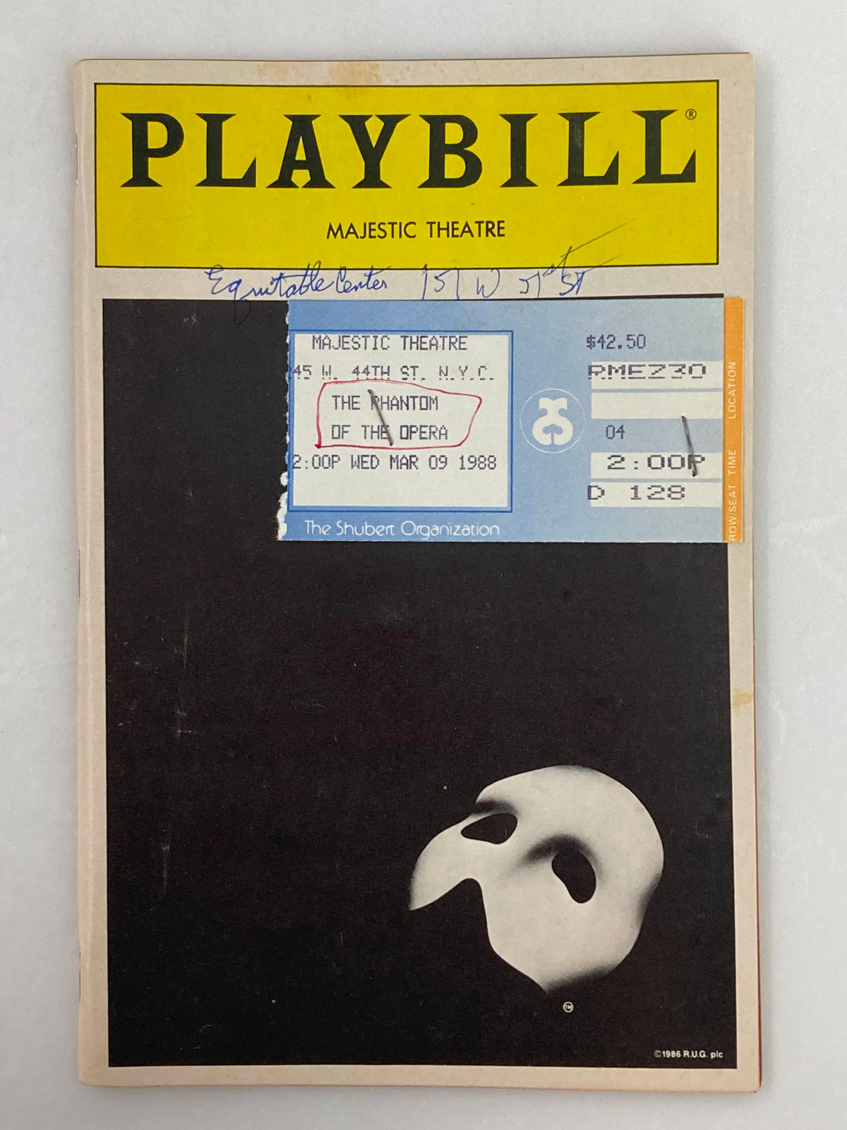 Cover of the 1988 Playbill from Majestic Theatre featuring Michael Crawford in The Phantom of the Opera, showcasing the iconic mask symbol and play details.