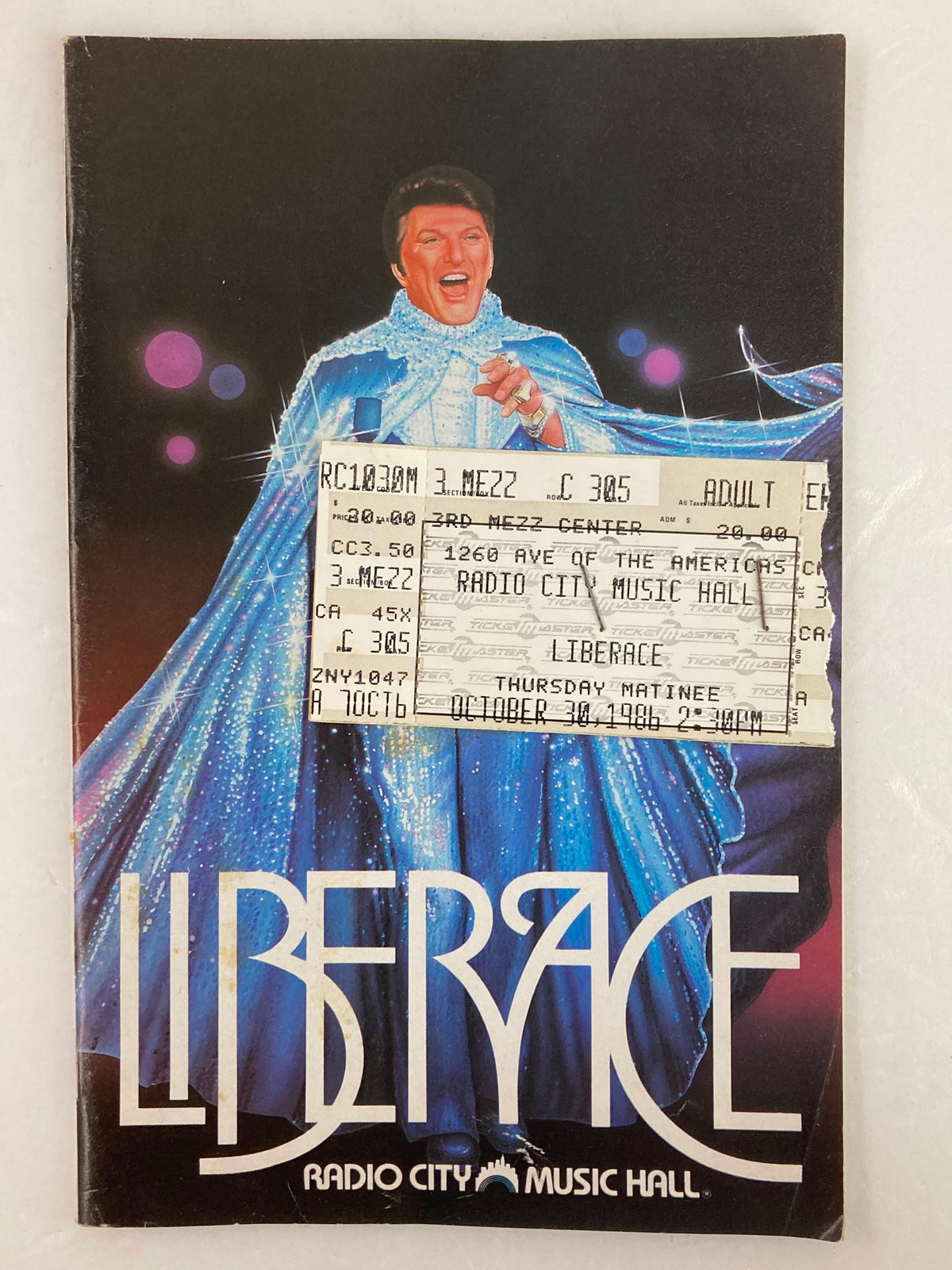 1986 Radio City Music Hall Program featuring Liberace with a ticket attached, celebrating the show with The Rockettes and Dancing Waters.