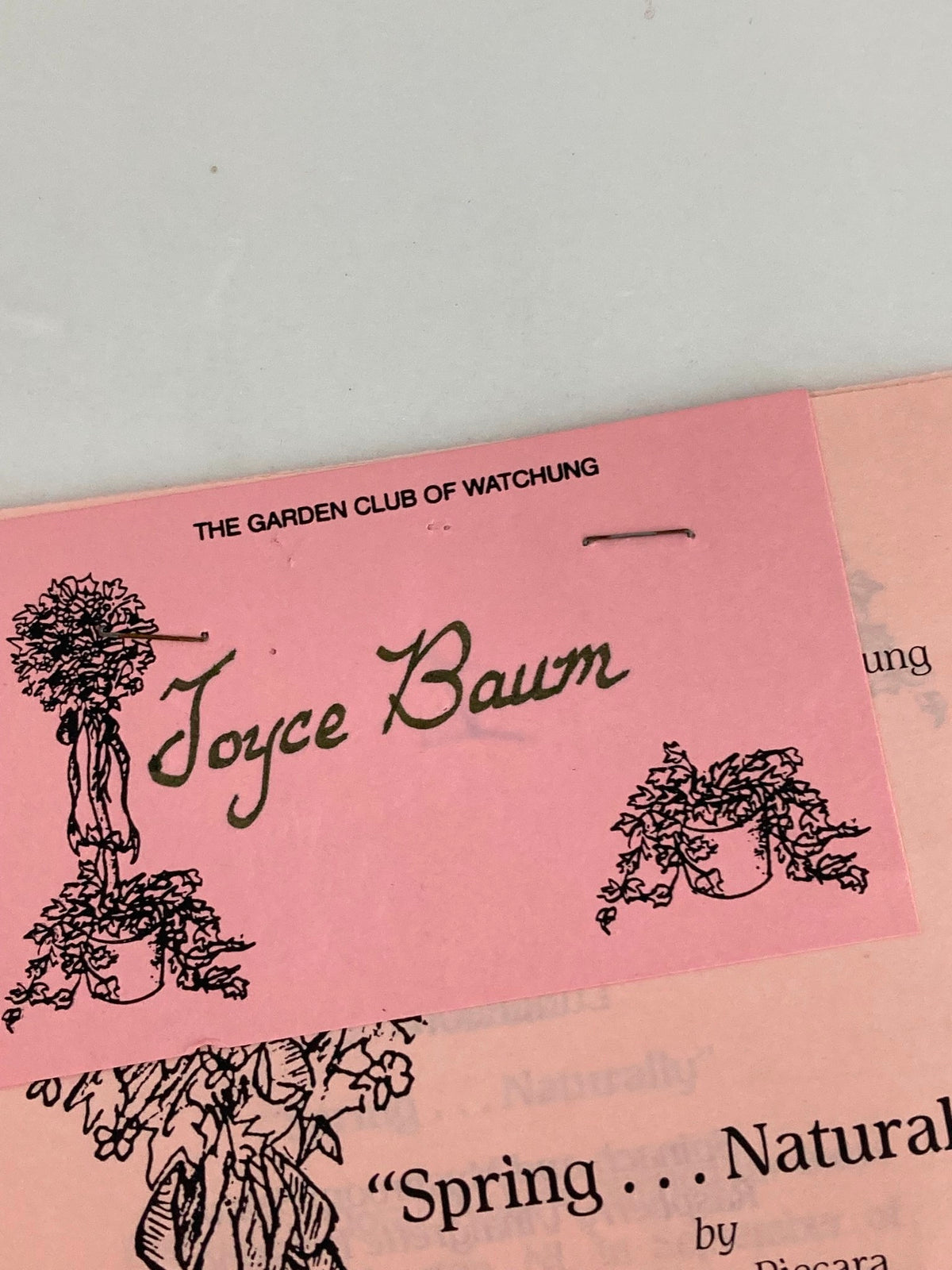 Close-up of the title on the cover of '1990 The Garden Club of Watching Spring Naturally' by Mr. Thom Piecera, highlighting the name Joyce Baum.