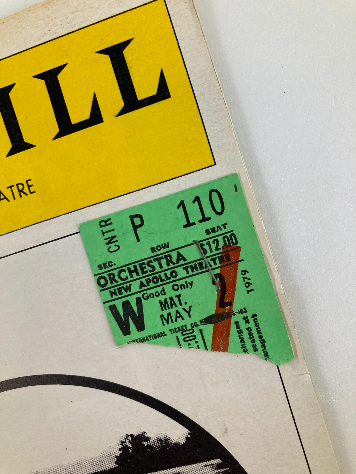 Close-up image of a ticket stapled to the 1979 Playbill for 'On Golden Pond', indicating the seating details and performance date at the New Apollo Theatre.