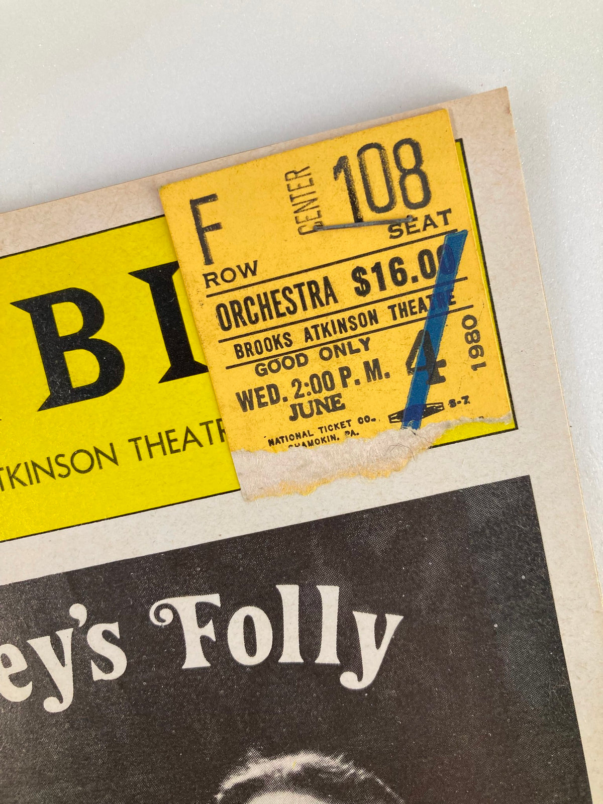 Close-up of the ticket stub attached to the 1980 Playbill for Talley's Folly, indicating orchestra seating and performance details at Brooks Atkinson Theatre.
