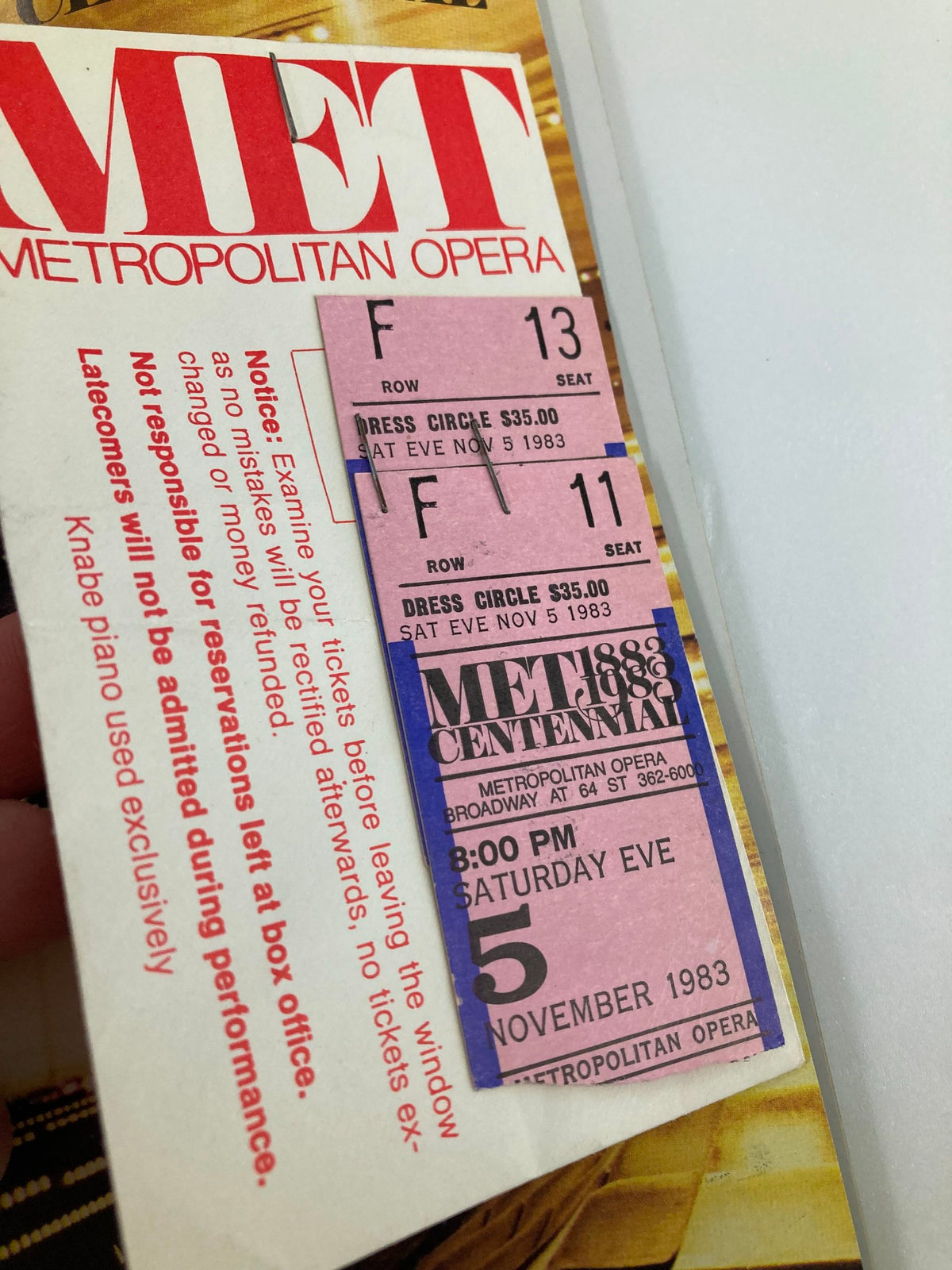 Close-up view of the 1983 Stagebill Lincoln Center including ticket stubs for the performance of La Boheme, featuring details like row and seat information.