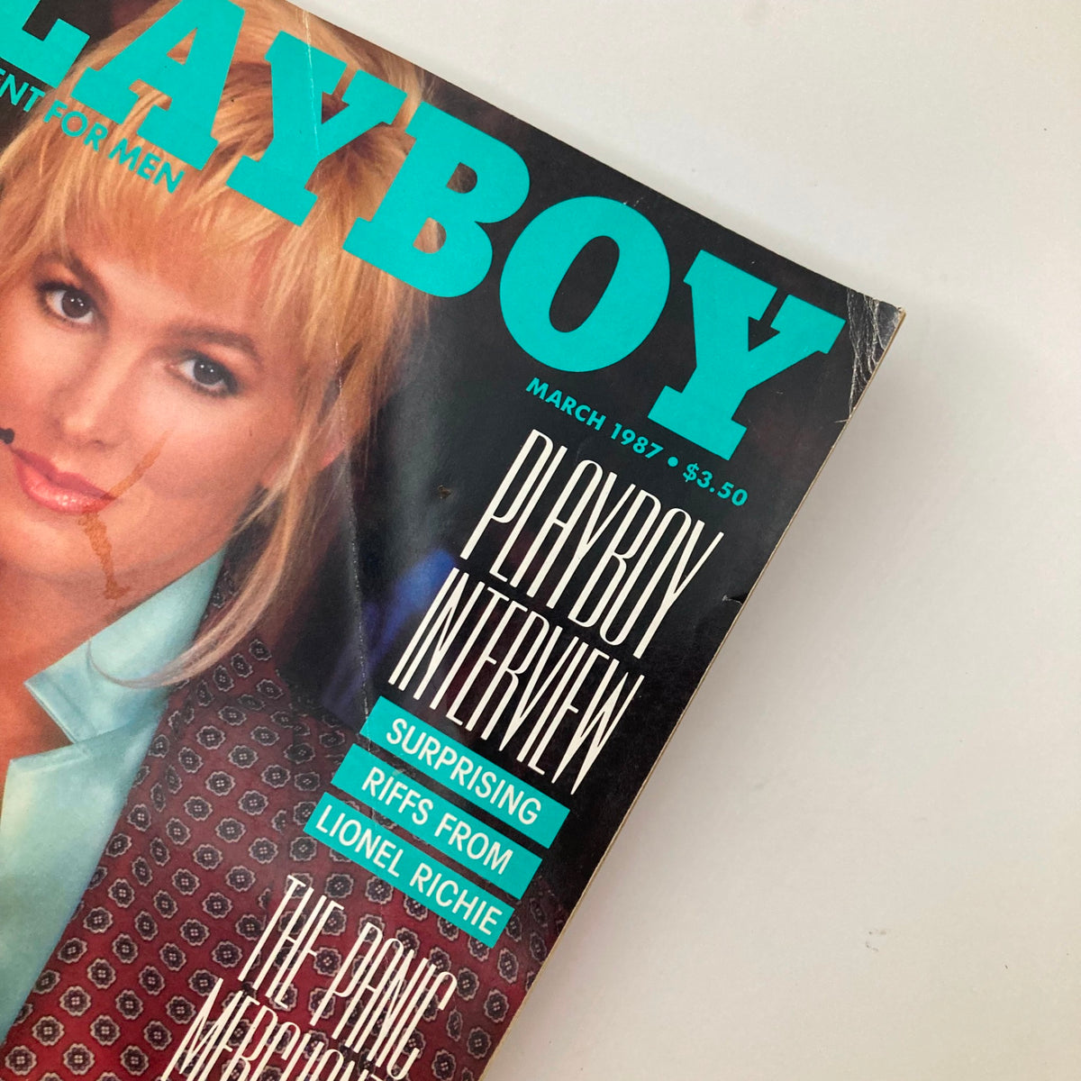 Close-up view of the VTG Playboy Magazine March 1987 cover with Janet Jones, highlighting playful details and magazine title.