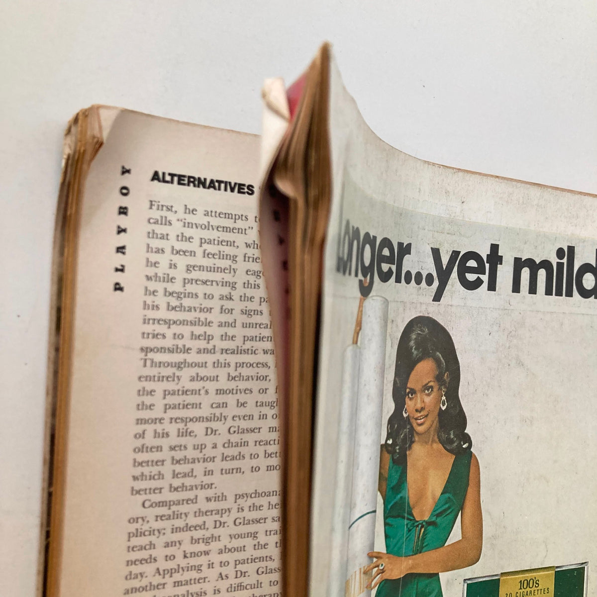 Detailed shot of the interior edge of the VTG Playboy Magazine November 1969 with Claudia Jennings, showing text and images from a classic article, reflecting the magazine's cultural context.