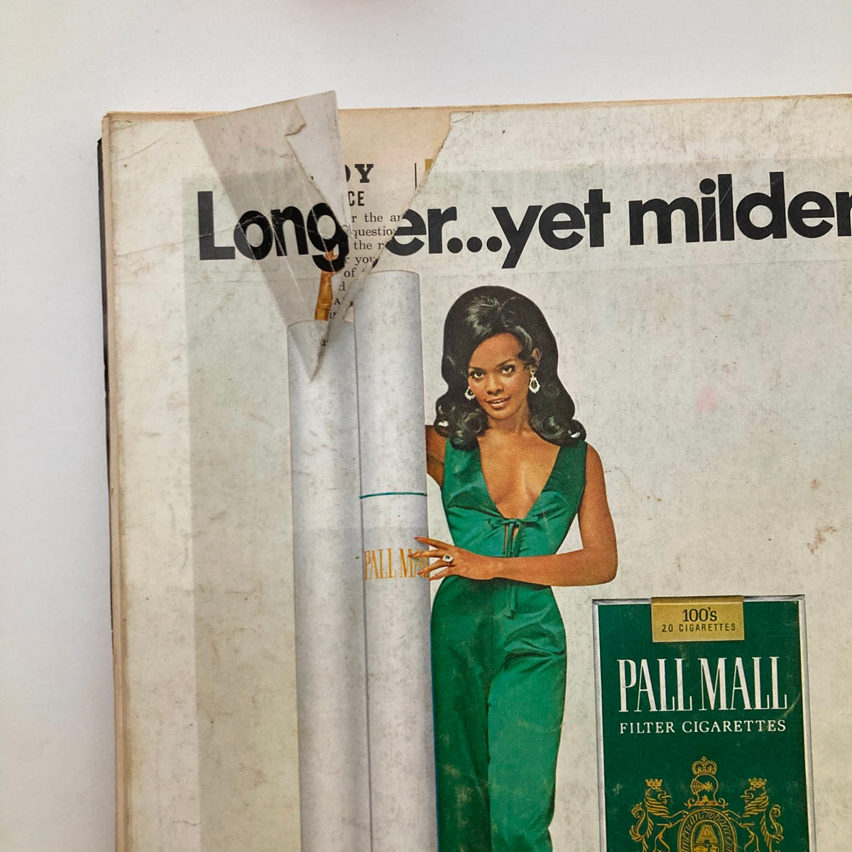 Close-up of the Pall Mall cigarette advertisement from Playboy Magazine November 1969, highlighting a model in a green dress with an elegant pose.