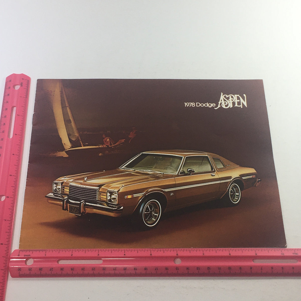 1978 Dodge Aspen Special Edition Paint Dealership Car Auto Brochure Catalog featuring a gold Dodge Aspen parked, highlighting its classic design and chrome accents.