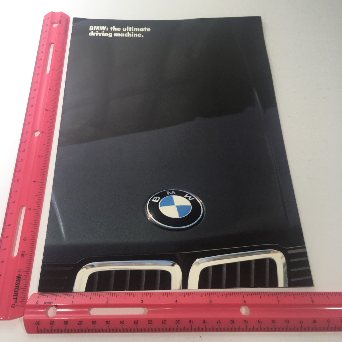 Cover of the 1994 BMW 7 Series 735i Dealership Car Auto Brochure alongside a ruler for size reference, emphasizing the BMW brand logo.