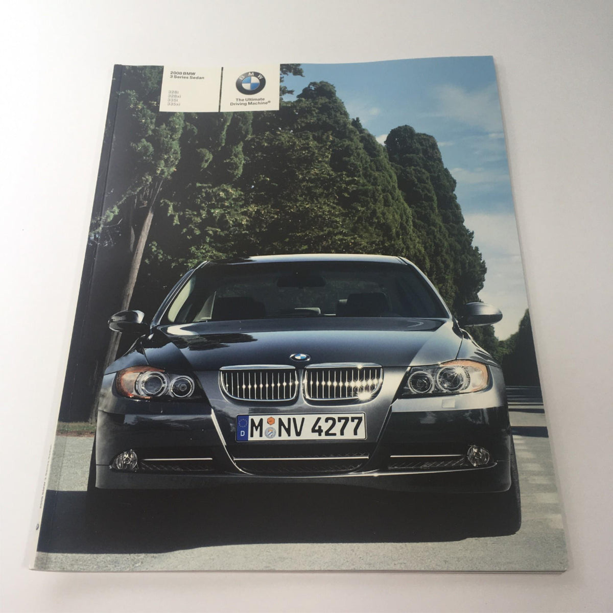 2008 BMW 3 Series Sedan 335i 335xi Dealership Car Auto Brochure Catalog cover featuring a sleek black BMW car parked on a tree-lined road.