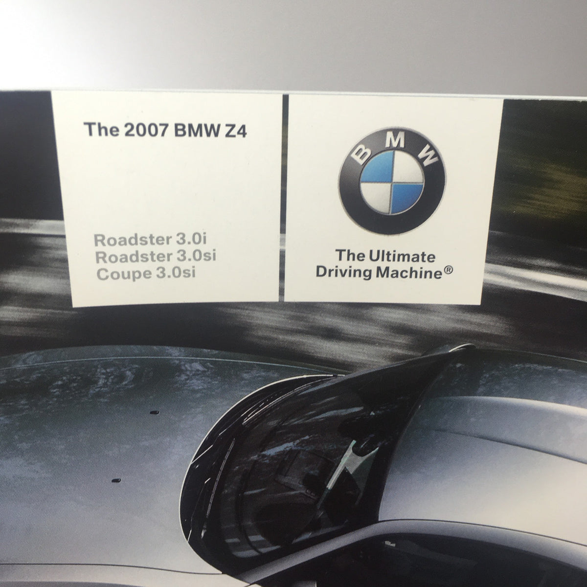 Details of the 2007 BMW Z4 Roadster 3.0i 3.0si Coupe catalog highlighting the model specifications, branding, and signature 'The Ultimate Driving Machine' slogan.