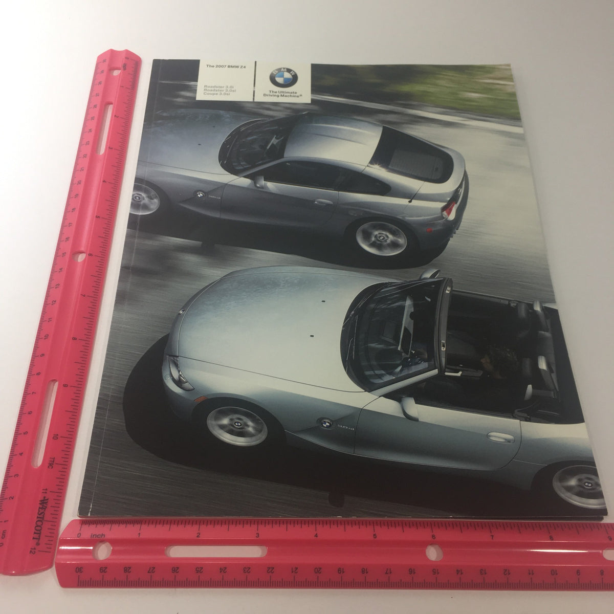 Aerial view of the 2007 BMW Z4 Roadster 3.0i 3.0si Coupe depicted in the catalog with a ruler for scale, emphasizing its stylish design.