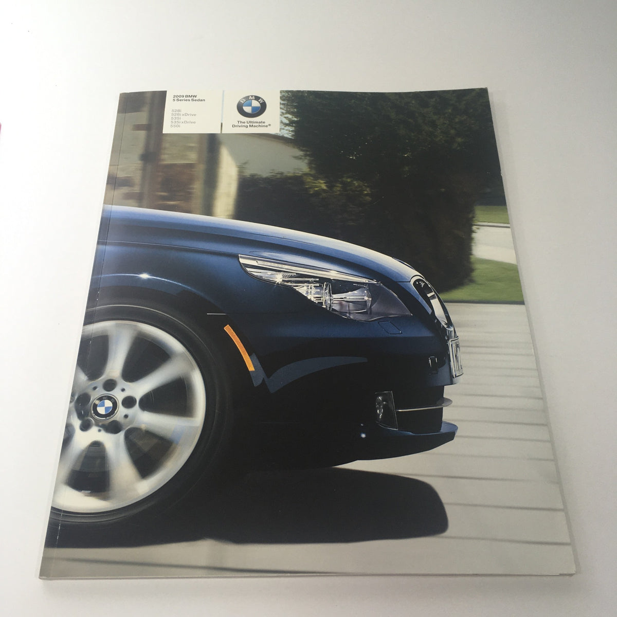 2009 BMW 5 Series Sedan 528i 528i-xDrive Dealership Car Auto Brochure Catalog cover featuring the car's sleek design and alloy wheel.