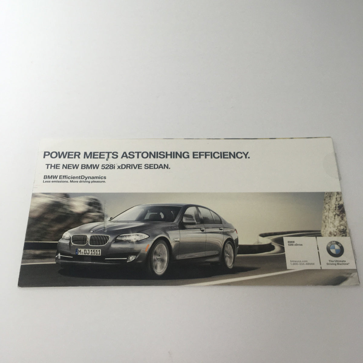 2009 BMW 528i xDrive Dealership Car Auto Brochure Catalog featuring an image of the BMW 528i xDrive sedan, showcasing its efficient design and luxurious appearance.
