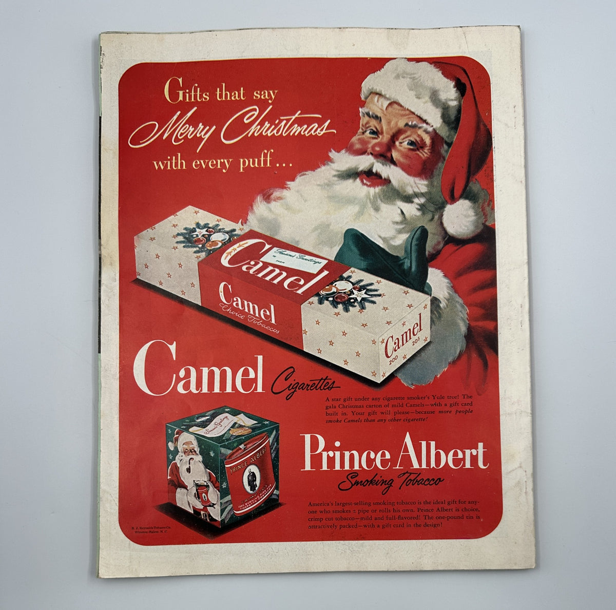 Cover of Woman’s Home Companion Magazine December 1950 featuring Santa Claus and a Camel cigarette advertisement, emphasizing holiday theme.