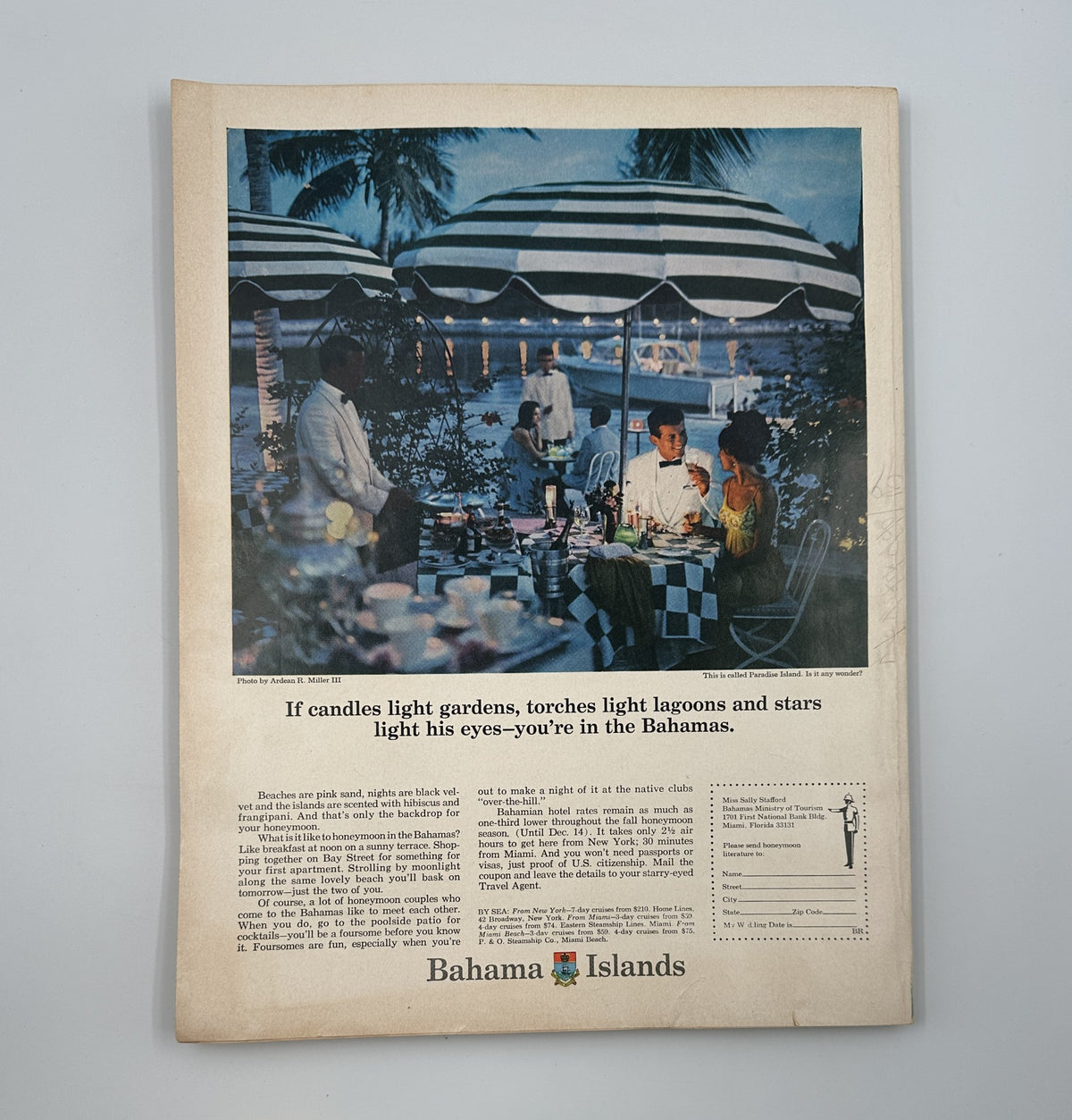 Advertisement for Bahama Islands featured in Bride's Magazine August/September 1967, showcasing a romantic dining scene under striped canopies, highlighting the allure of a honeymoon destination.