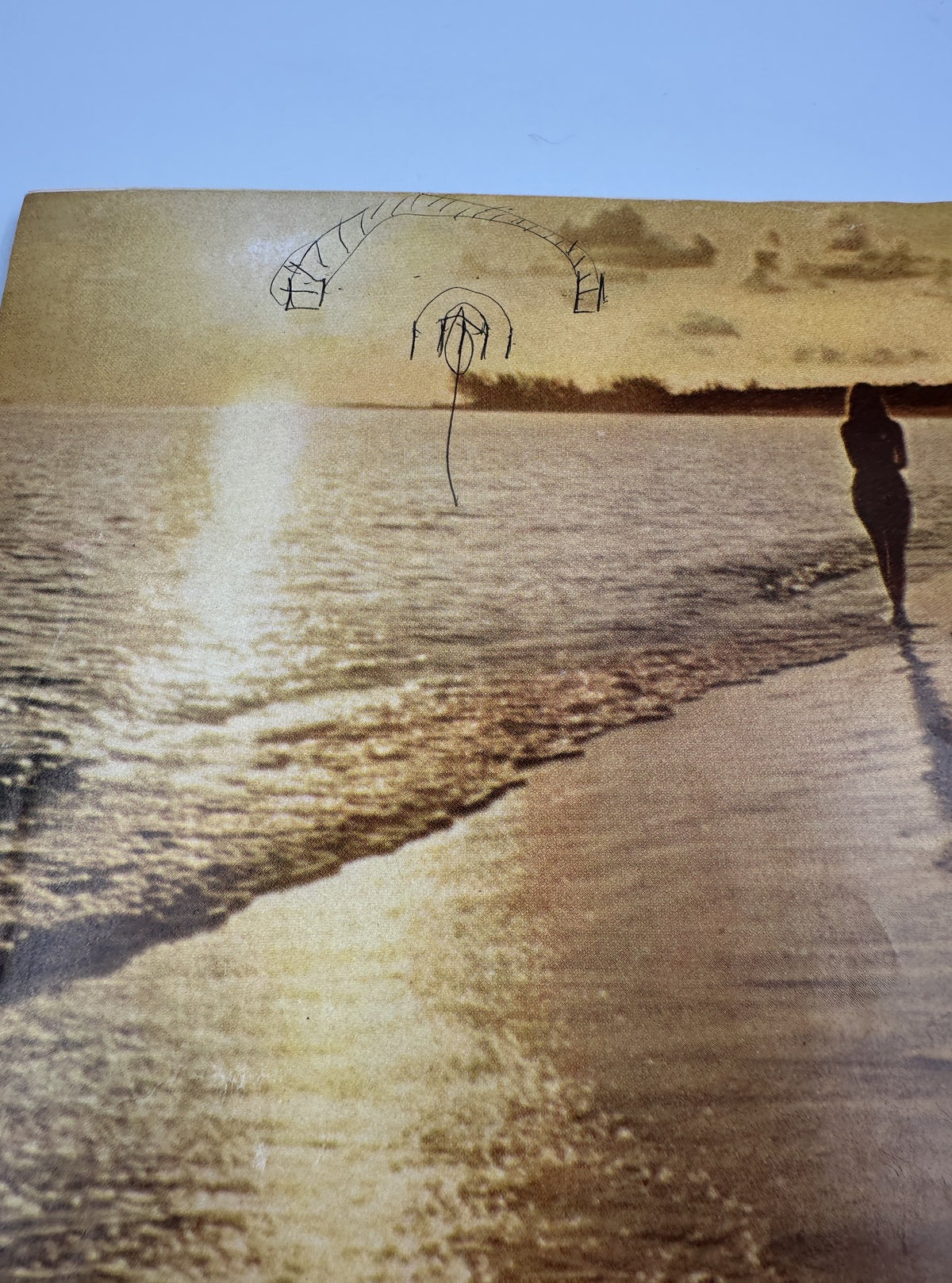 Back cover of Bride's Magazine December/January 1967-68 with a serene sunset beach scene, suggesting a romantic getaway for newlyweds.