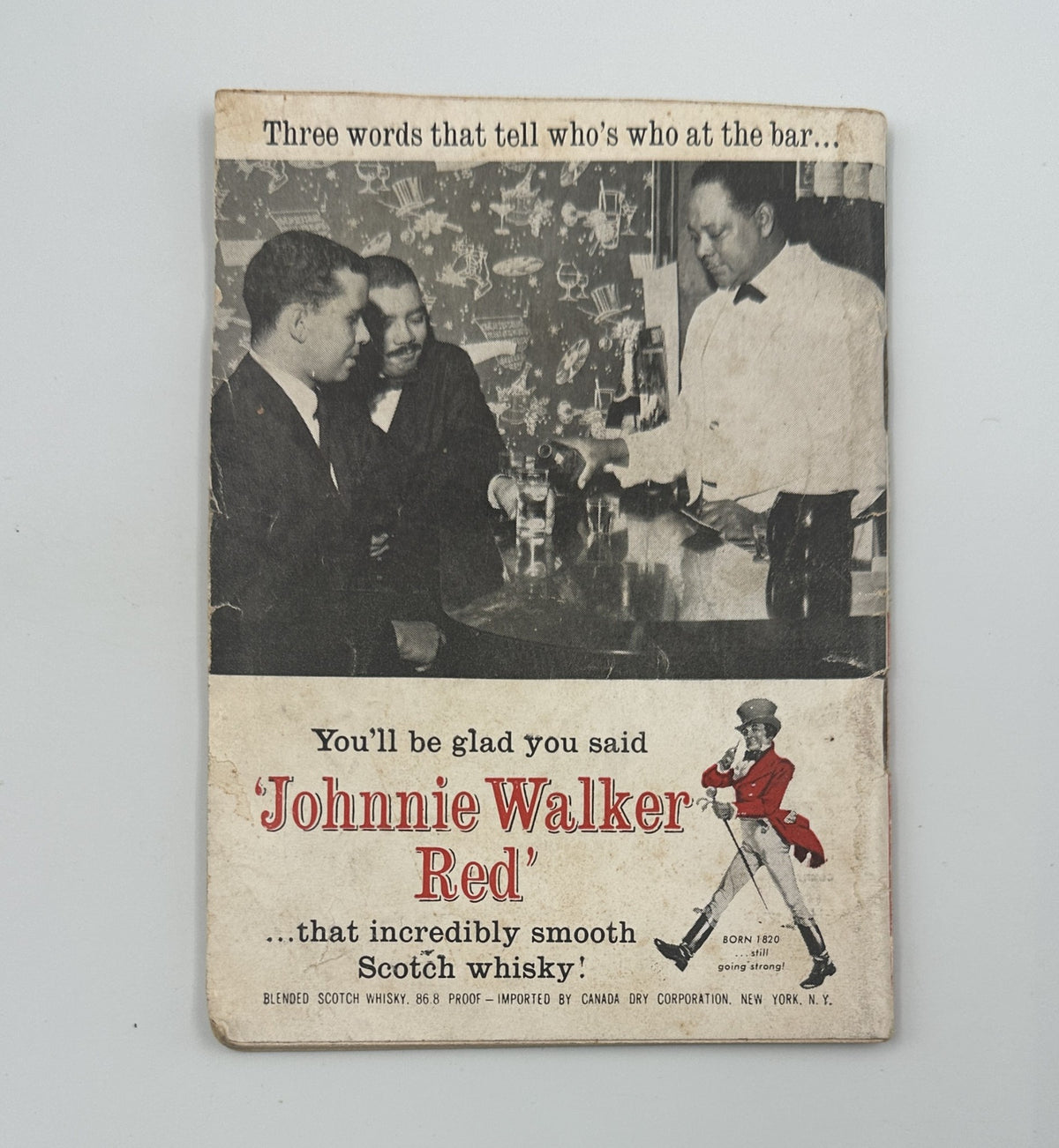 Jet Magazine December 31, 1964 ad for Johnnie Walker Red whisky, featuring three men at a bar, emphasizing the product's appeal.