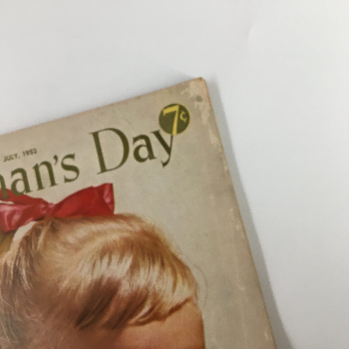 Close-up of the title on the cover of the VTG Woman's Day Magazine July 1952, highlighting the magazine's vintage charm.