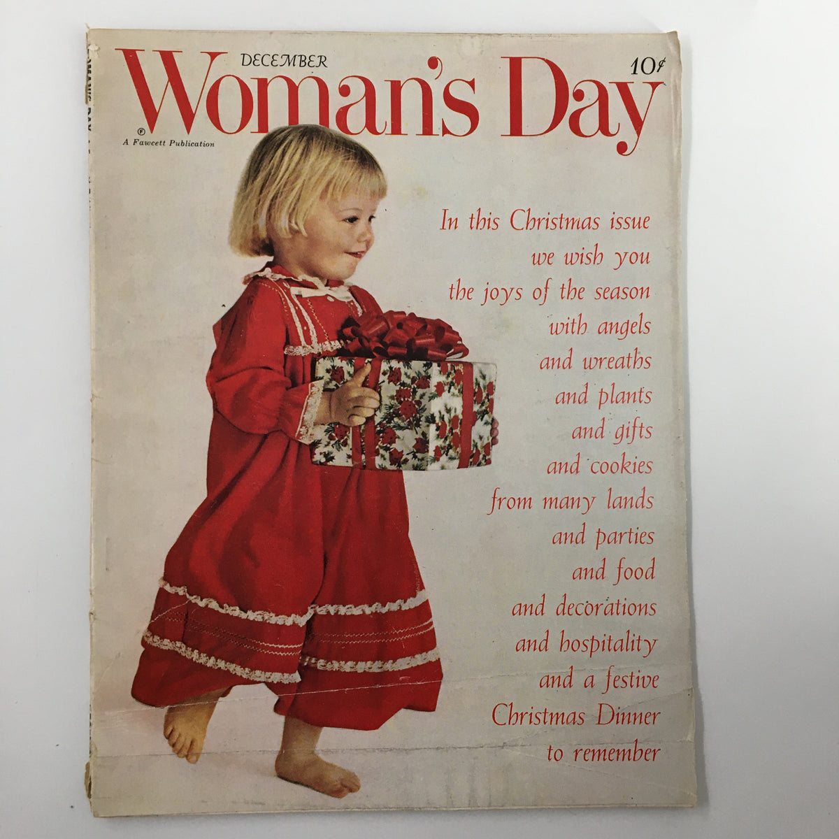 Cover of Vintage Woman's Day Magazine December 1961 featuring a young girl in a red dress holding a Christmas present, showcasing holiday themes and nostalgic design.