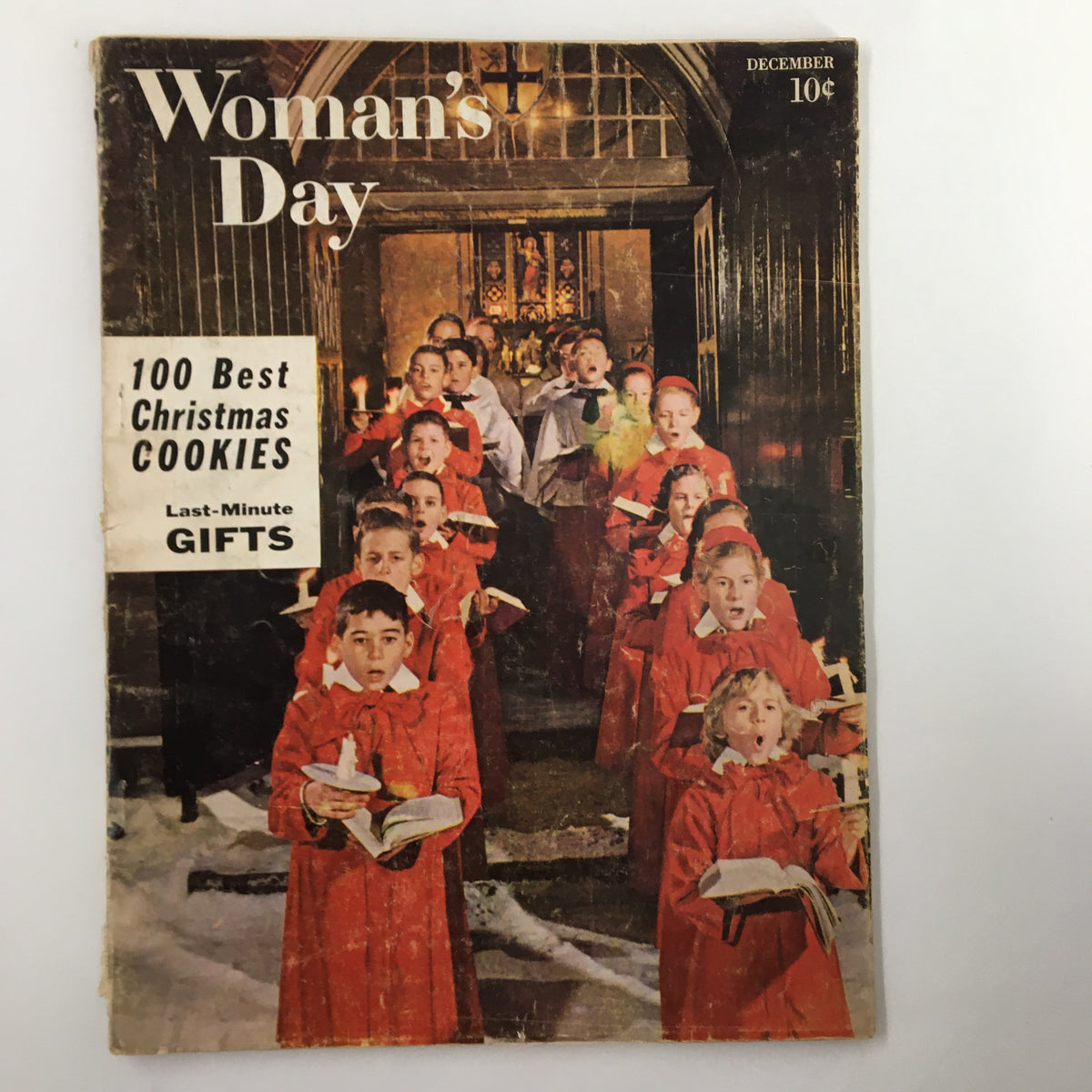 VTG Woman's Day Magazine Cover from December 1957 featuring children in red choir robes, holding candles and songbooks, showcasing the theme of Christmas and holiday spirit.