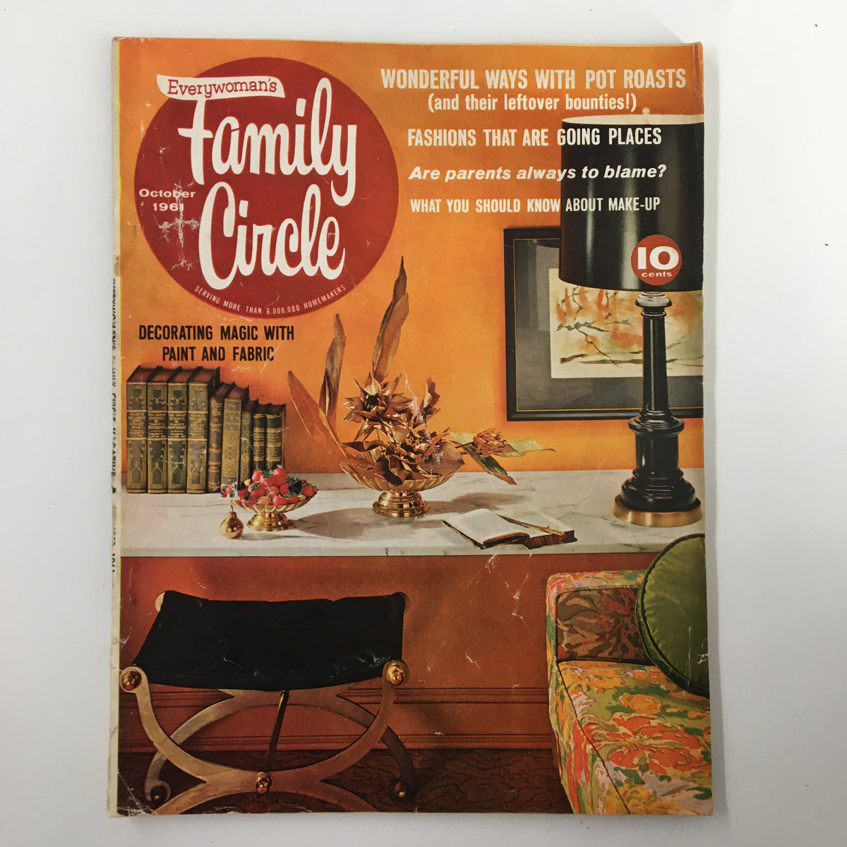 Cover of the Family Circle Magazine, October 1961, featuring a vibrant orange background and text about decorating with paint and fabric, showcasing mid-century design elements.