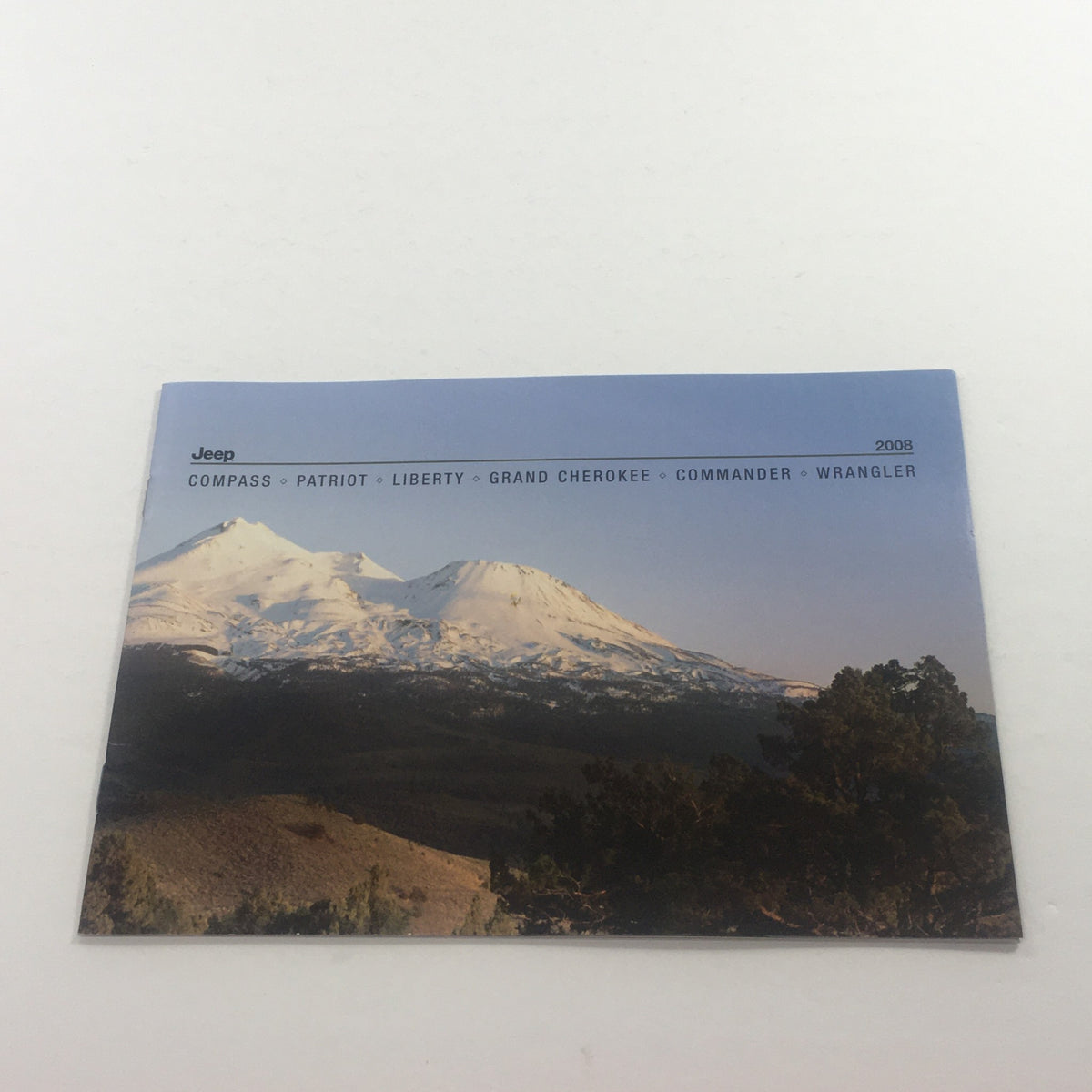 Front cover of the 2008 Jeep Compass Patriot Liberty Wrangler Dealership Car Auto Brochure Catalog featuring snowy mountains and various Jeep models.