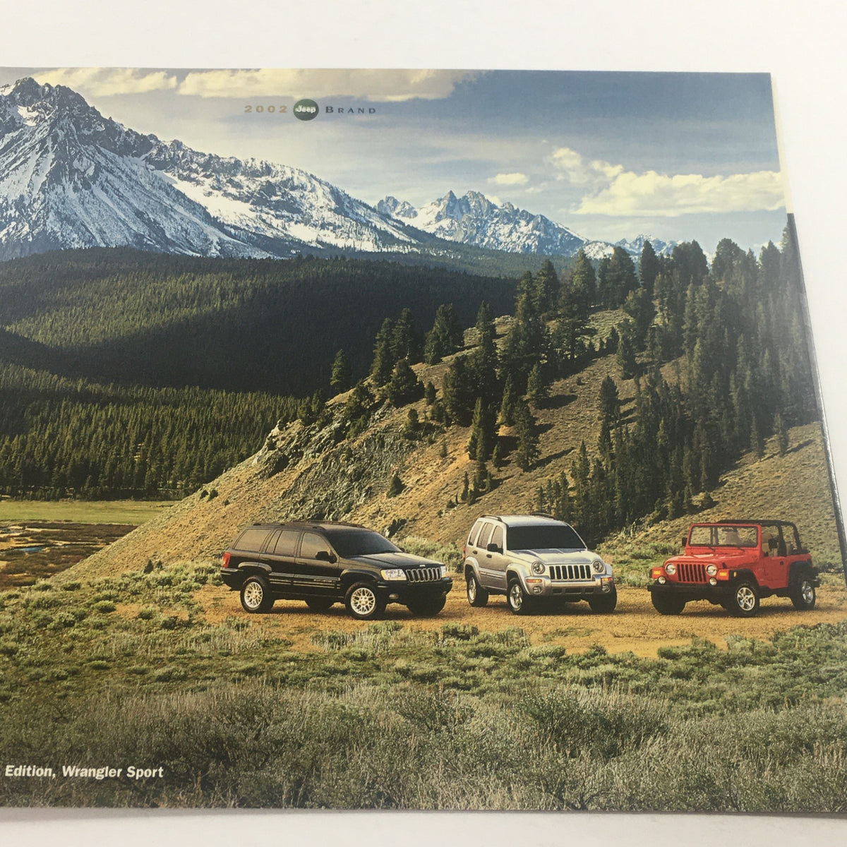 2002 Jeep Wrangler Sport Edition Dealership Car Auto Brochure Catalog image featuring three Jeep models in a scenic mountain landscape.