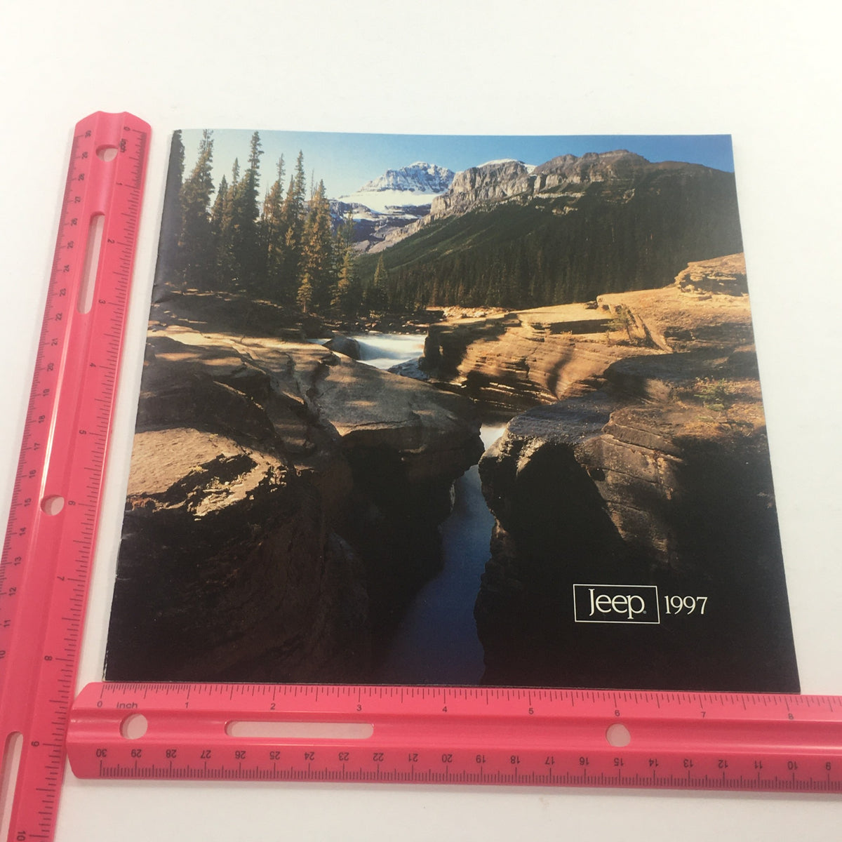 Cover of the 1997 Jeep 4-Wheel Drive Dealership Car Auto Brochure Catalog, displaying a scenic mountain view with a clear blue sky, trees, and the Jeep logo.