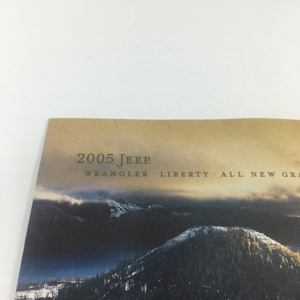 Close-up of the 2005 Jeep dealership brochure catalog cover, highlighting the text and design related to the Wrangler Liberty and Grand Cherokee models.