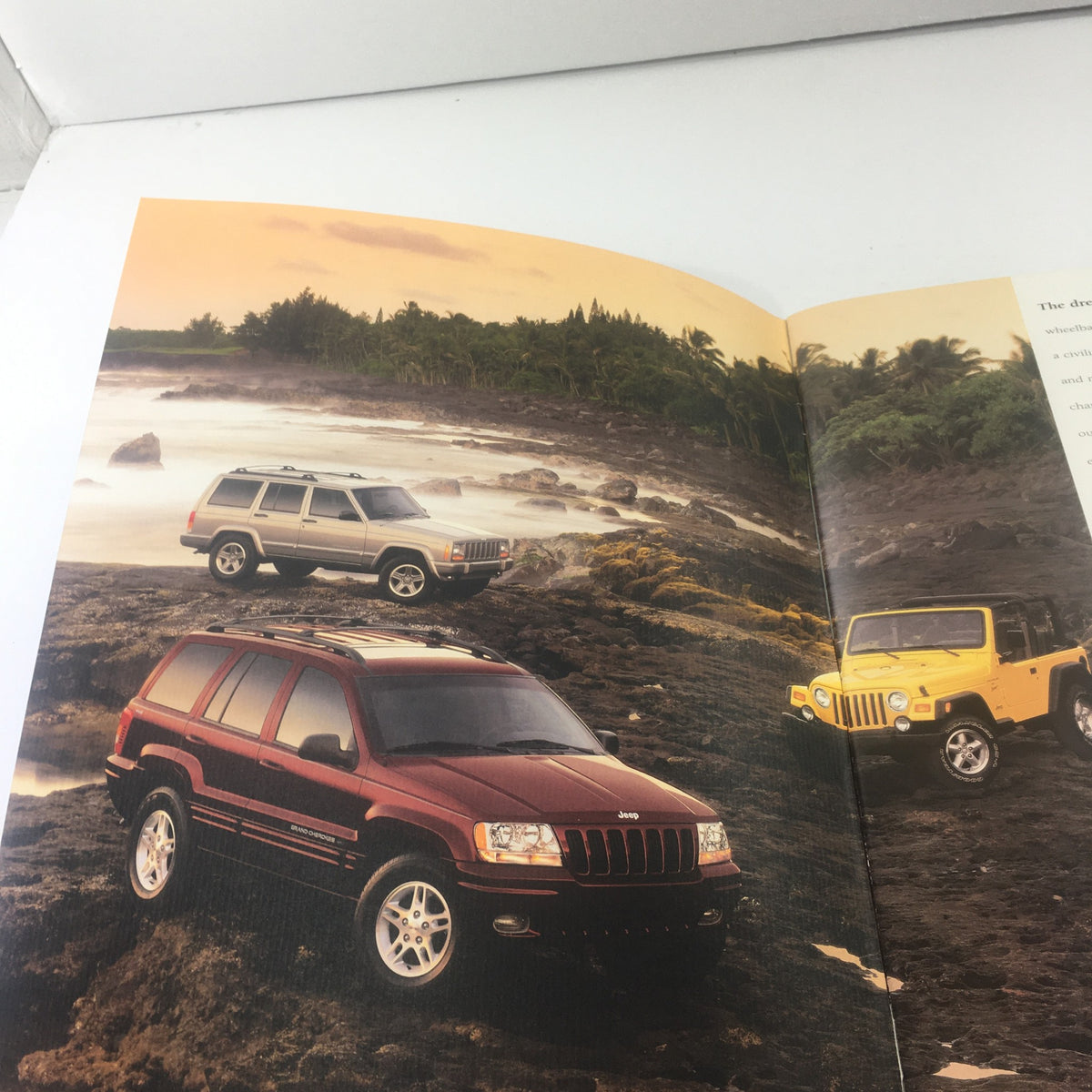 Interior page of the 2000 Jeep Cherokee, Grand Cherokee Wrangler Dealership Car Auto Brochure Catalog showcasing Jeep vehicles against a scenic coastal backdrop.