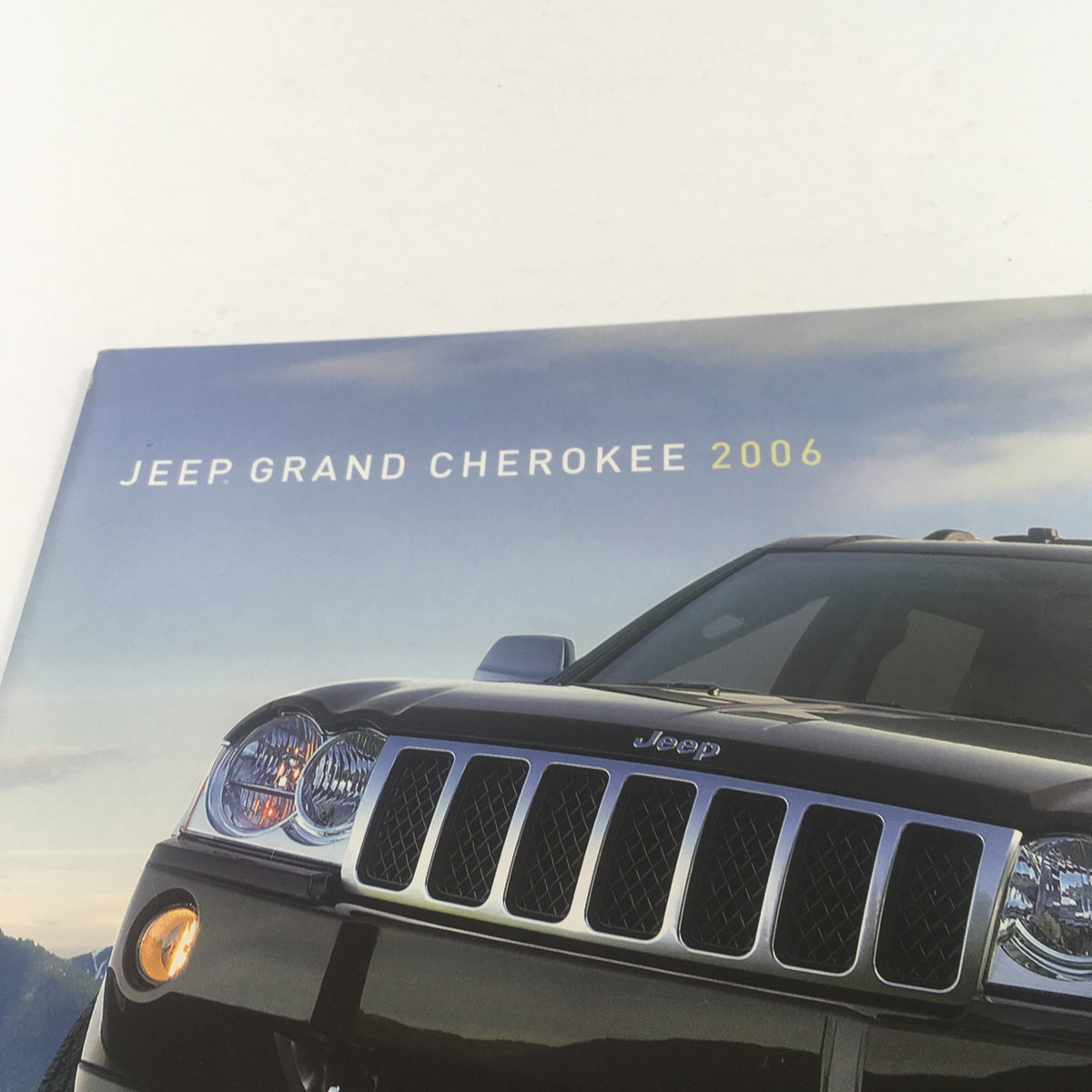 Cover of the 2006 Jeep Grand Cherokee Dealership Car Auto Brochure Catalog featuring the front view of a Jeep Grand Cherokee.